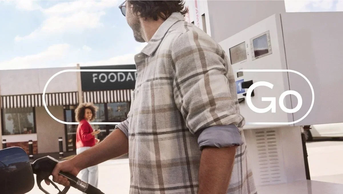 Toyota Go: a customer refuelling, with the Go logo