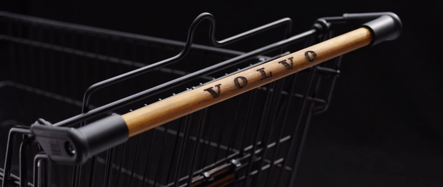 A shopping trolley with a wooden Volvo handle