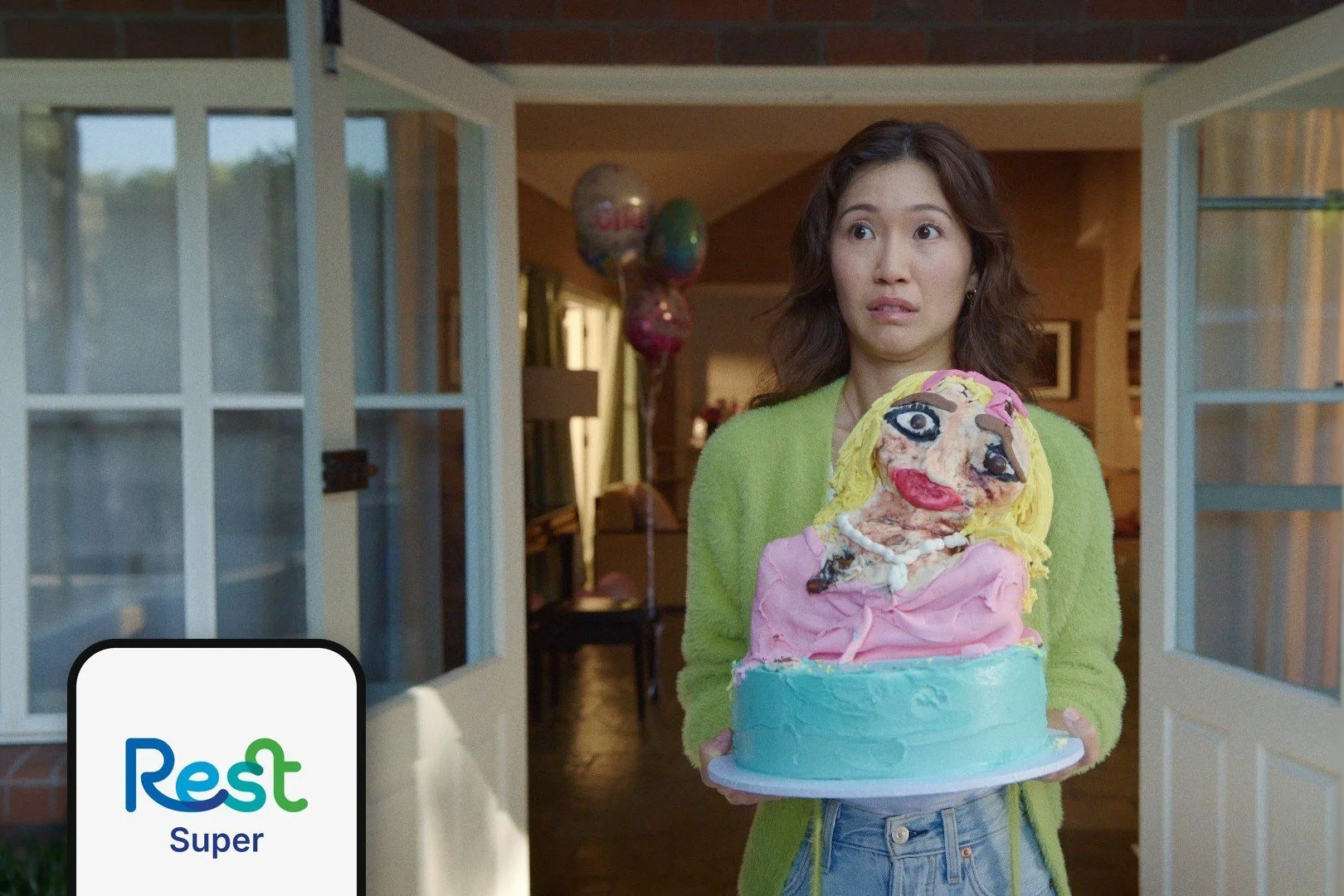 01-a-woman-in-a-doorway-holding-a-collapsing-birthday-cake-with.jpg