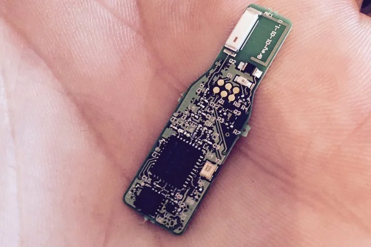 The SmartTooth circuit board in a palm