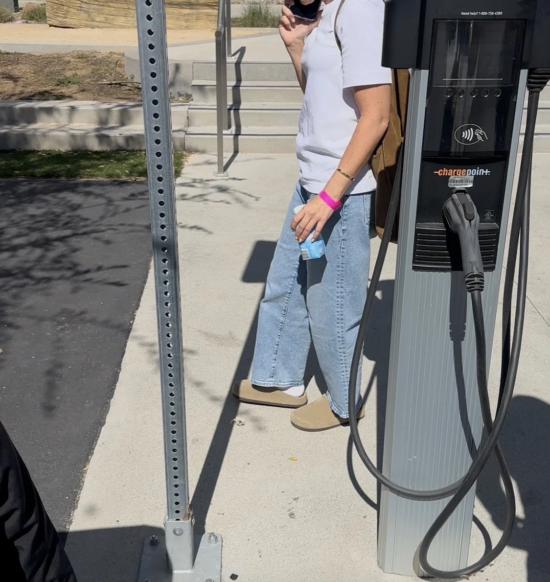 Guest wearing a pink color coded wristband outside the Hermès private sale in Los Angeles