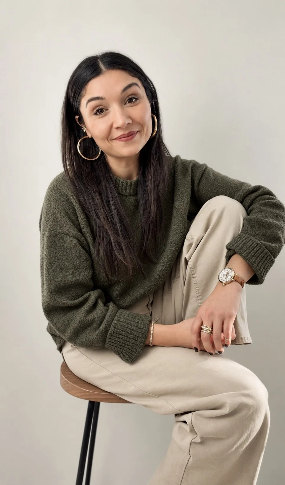 Dana Wray, therapist, seated in an olive green sweater against a neutral background.