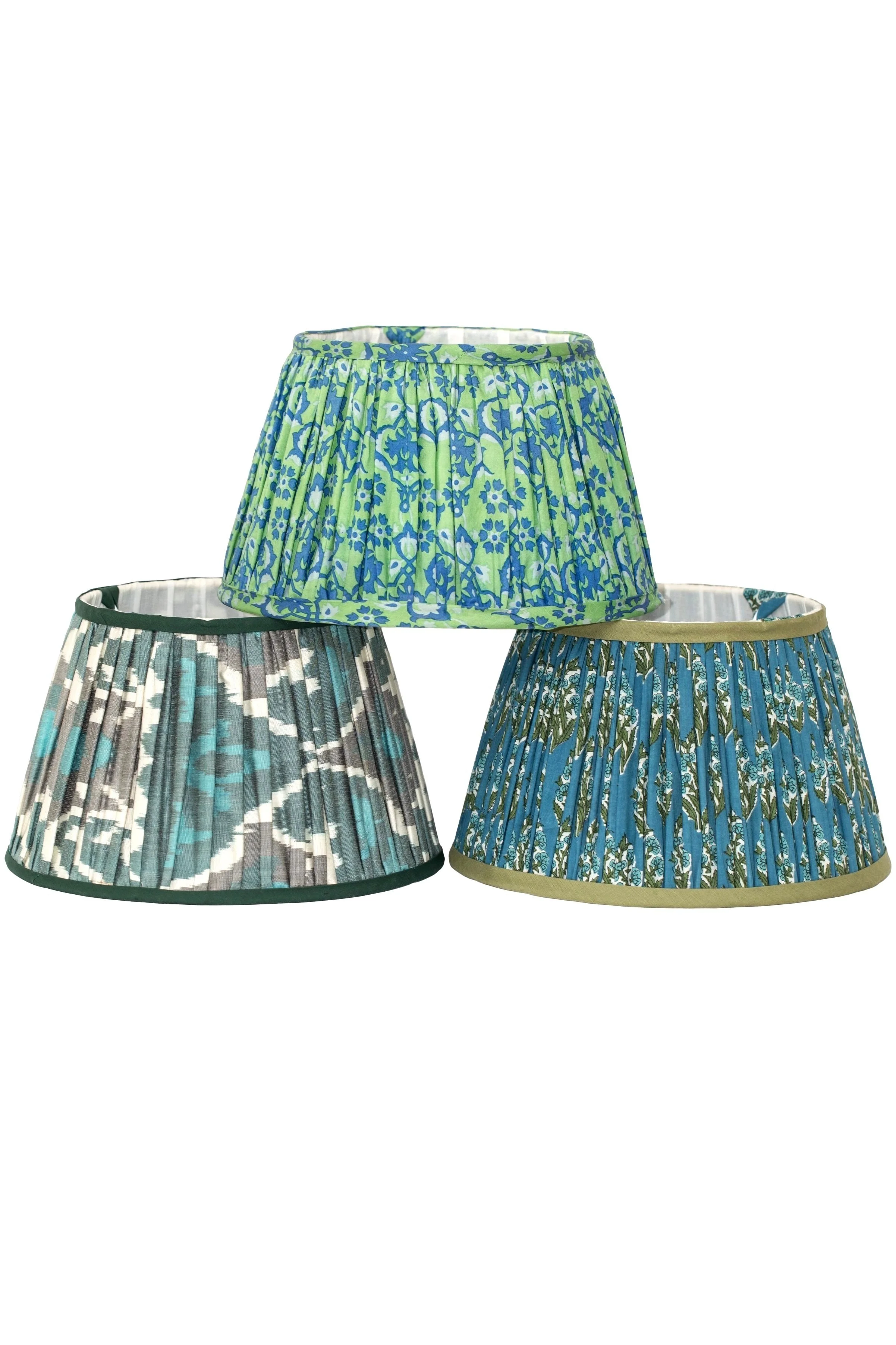 Three pleated fabric lampshades with blue and green floral patterns displayed against a white background.