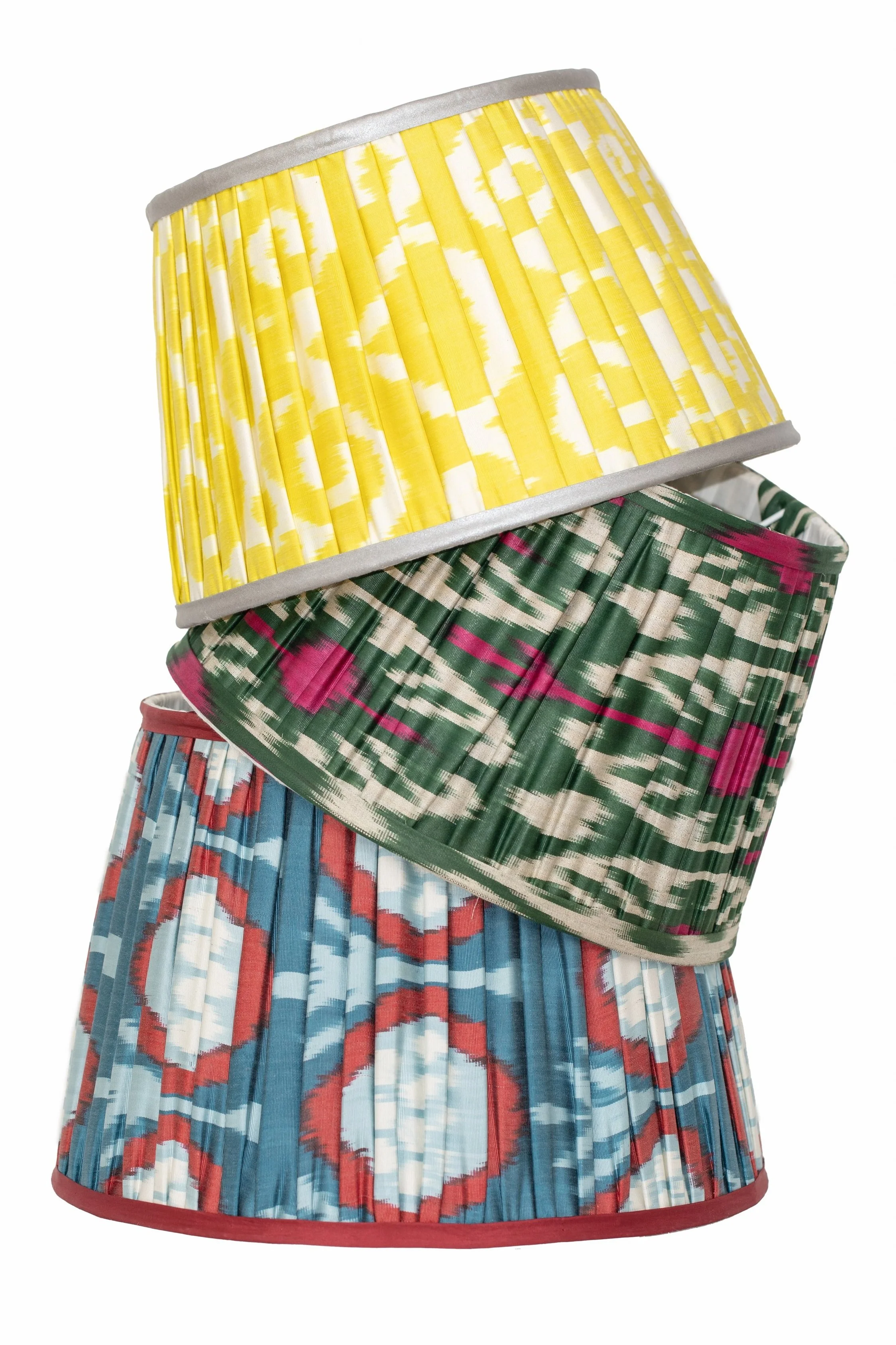Colorful, pleated skirt with red, blue, white, and gray abstract pattern, and a green and pink patterned overlay.