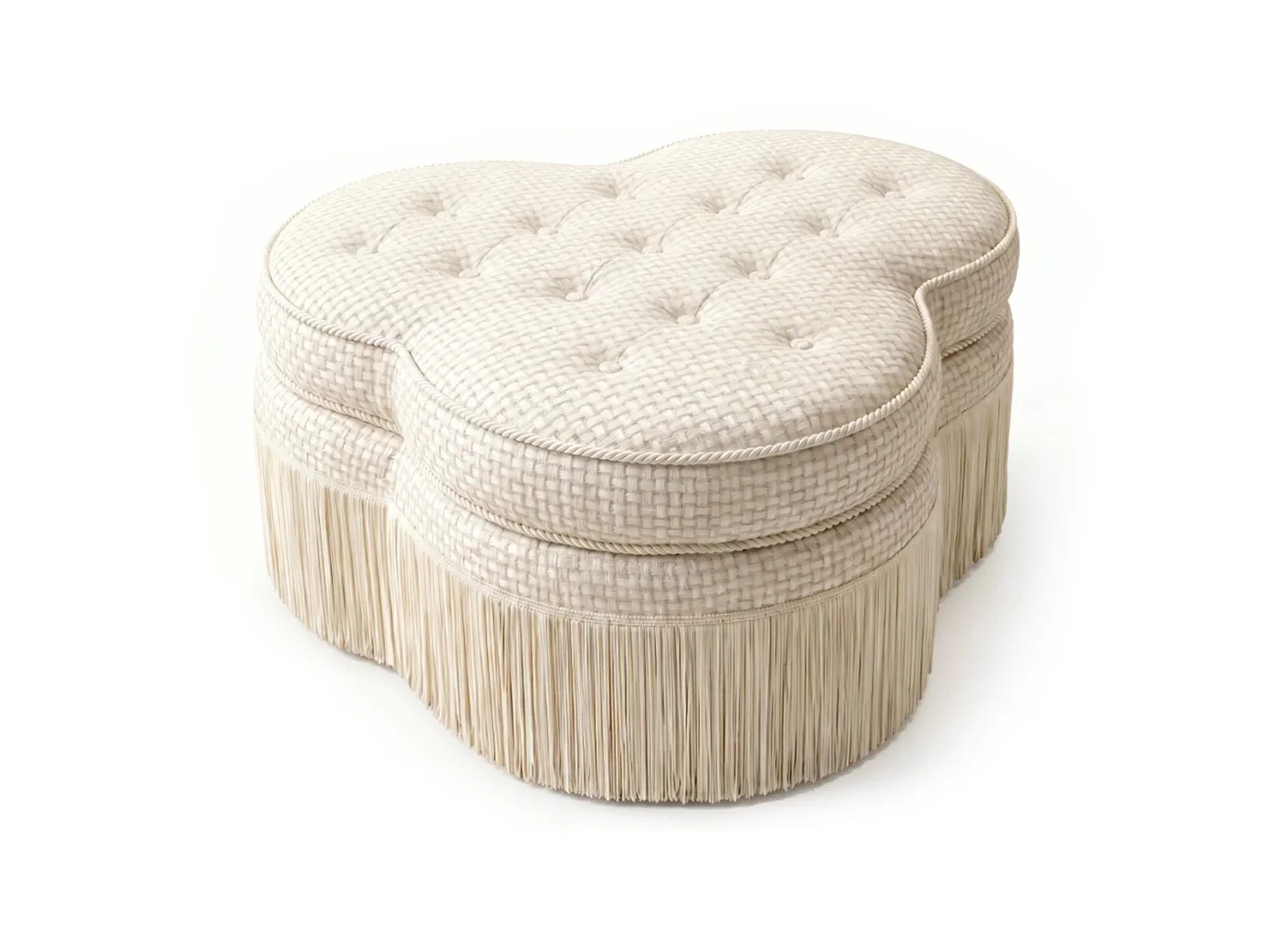 A vintage-style upholstered footstool with woven fabric and a fringed skirt, featuring a padded, tufted top.