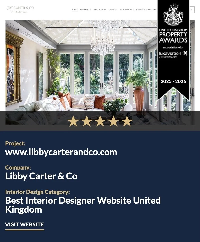 An award announcement for Libby Carter & Co, an interior design company, featuring a bright, elegant room with large windows, a chandelier, and a white sofa. The banner on indicates the company won the 'Best Design Website 2026'.