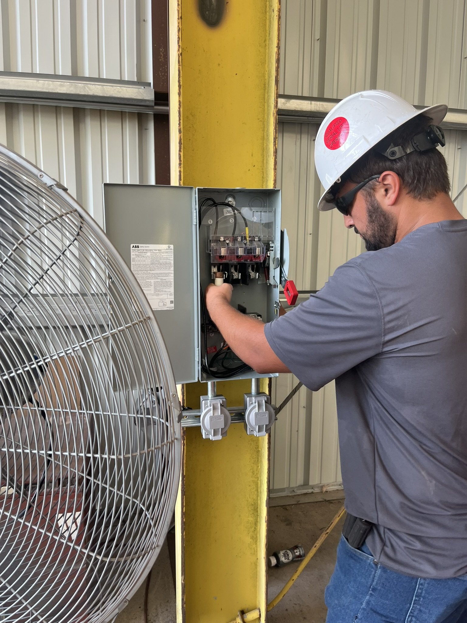 Licensed electrician wiring an industrial safety switch