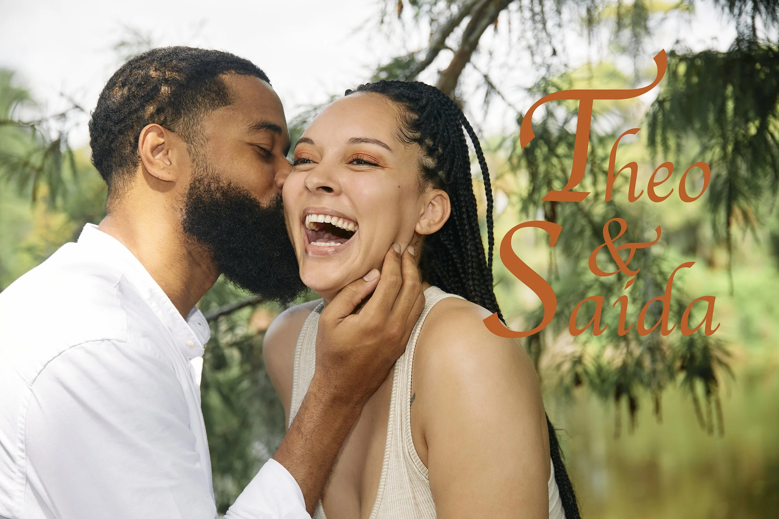 Happy couple outdoors in Nola's City Park, man kissing woman, with "Theo & Saida" text overlay in stylish font.