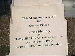 A memorial stone with an inscription honoring Emmeline Lucas and unidentified others, mentioning George Pillson, and noting its placement in 1930 after a loss at sea in 1930.