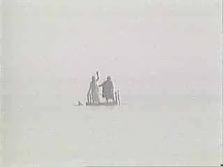 A small boat with three people in a vast, empty body of water with a clear, pale sky.