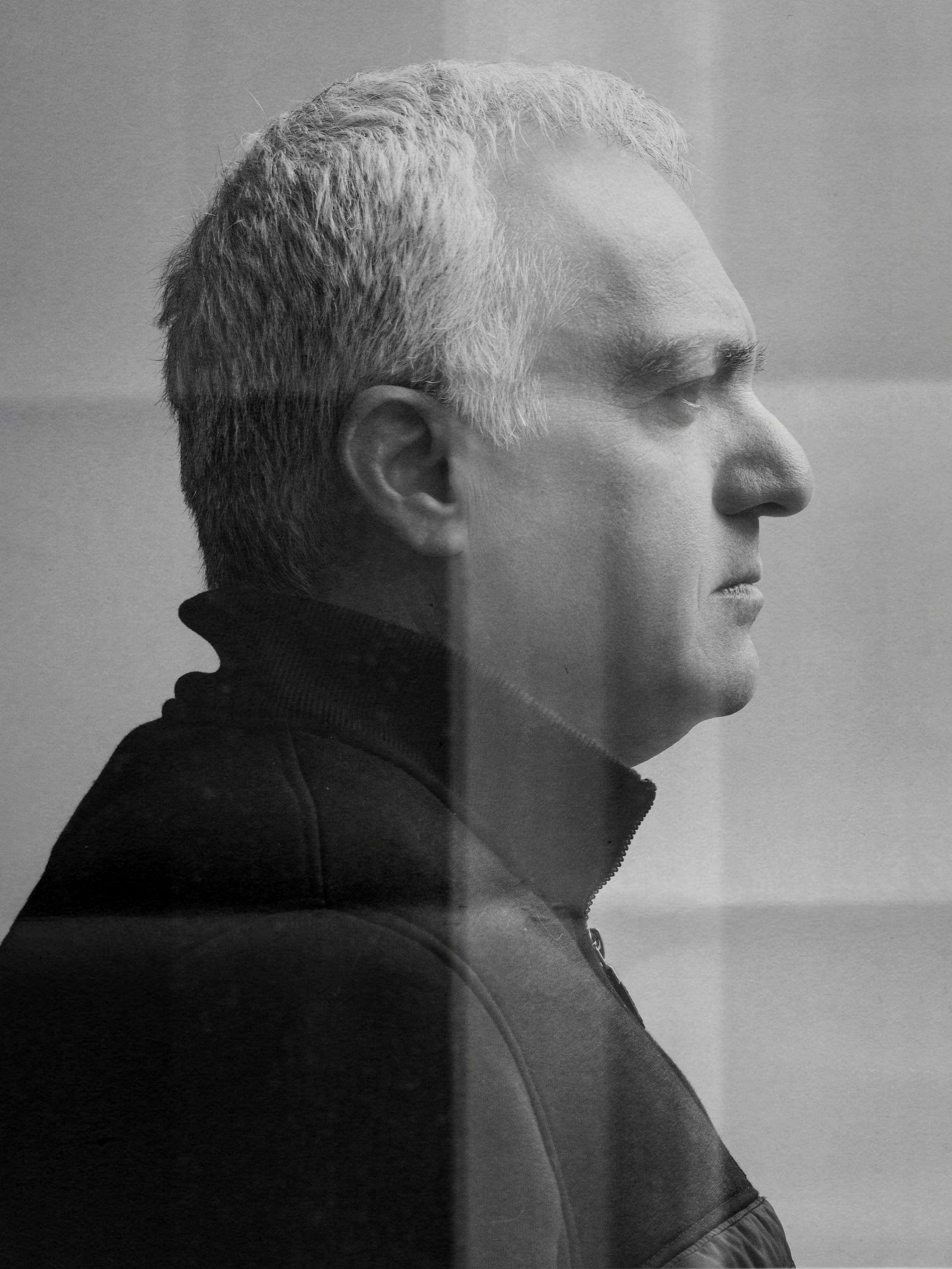 Black-and-white side-profile portrait of international chef Saman Golriz, Iran’s first male television cooking instructor, wearing a dark, high-collar jacket.