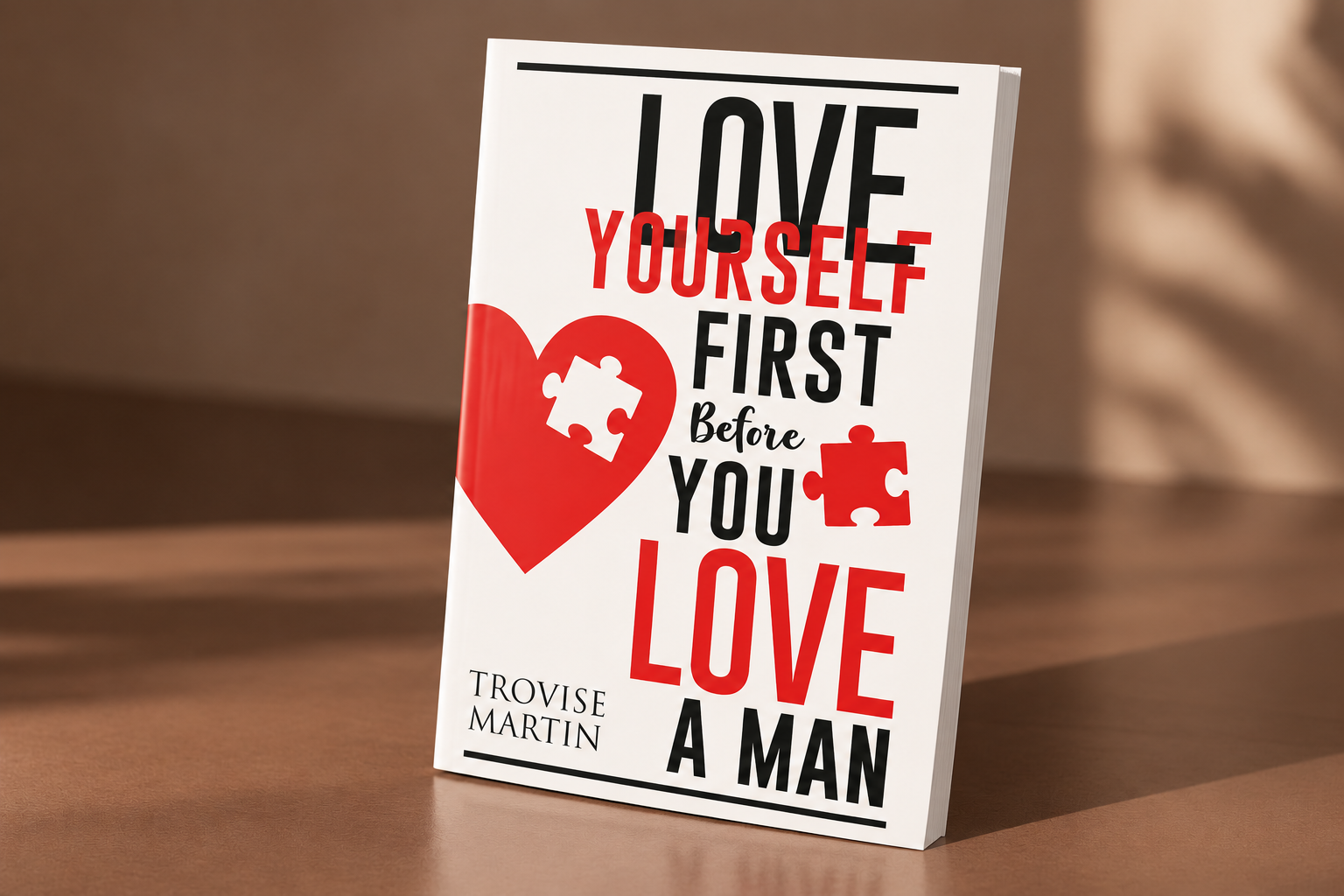 Book cover with the title 'Love Yourself First Before You Love A Man' by Trovise Martin, featuring a red heart with a puzzle piece and a red puzzle piece next to the text.
