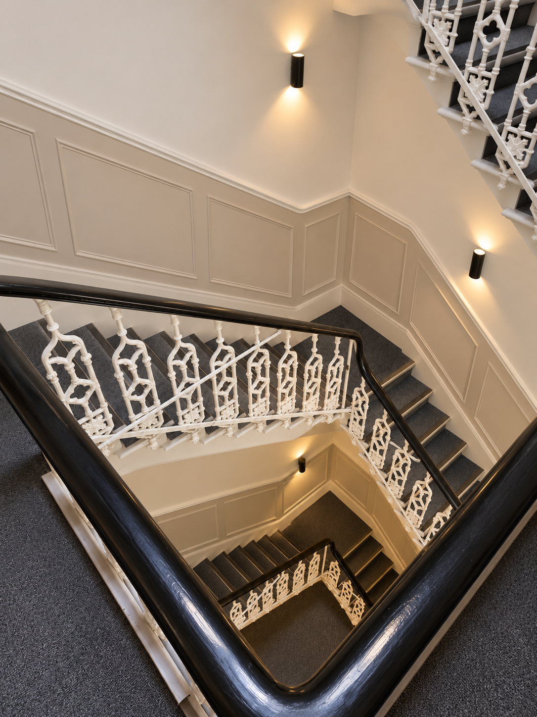 Renovated Period Stairwell with Ornate Ironwork.png