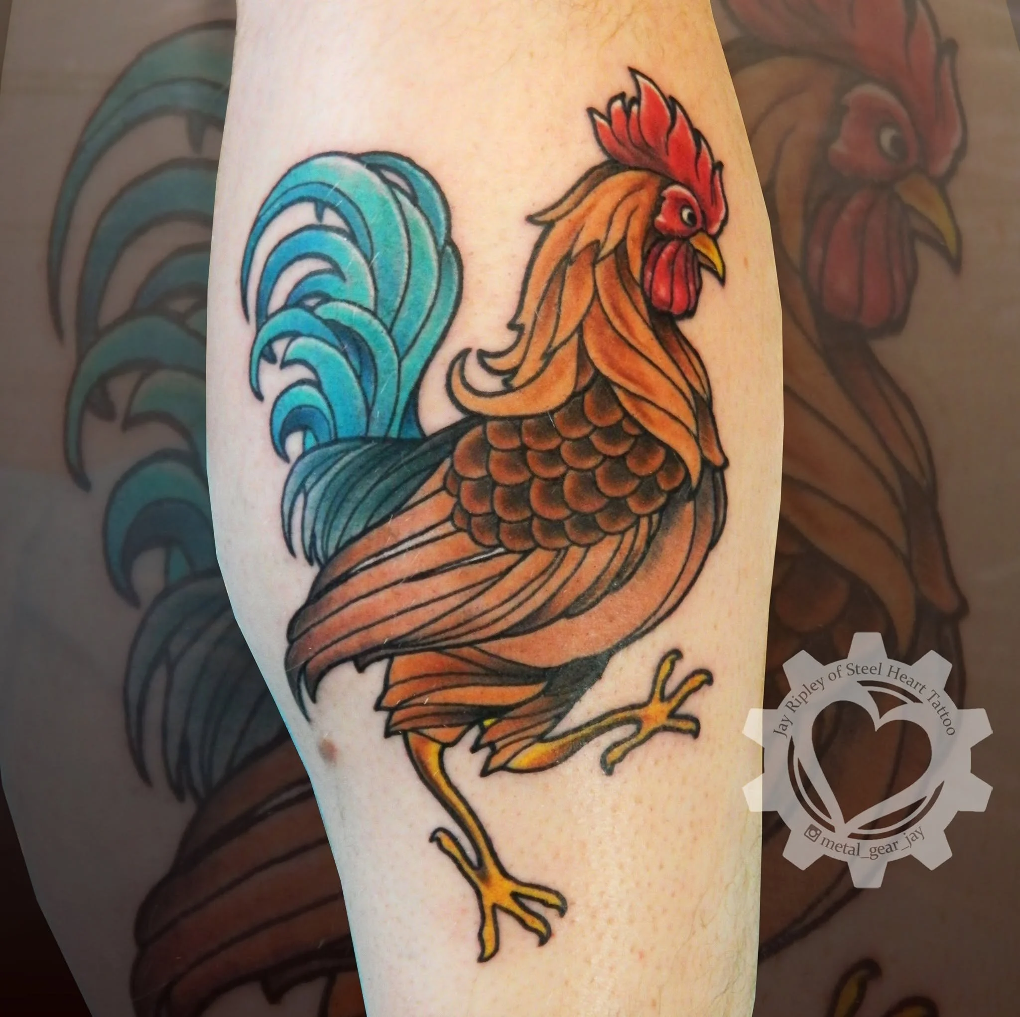 Colorful traditional-style rooster tattoo with bright blue tail feathers and orange-red plumage on a leg.