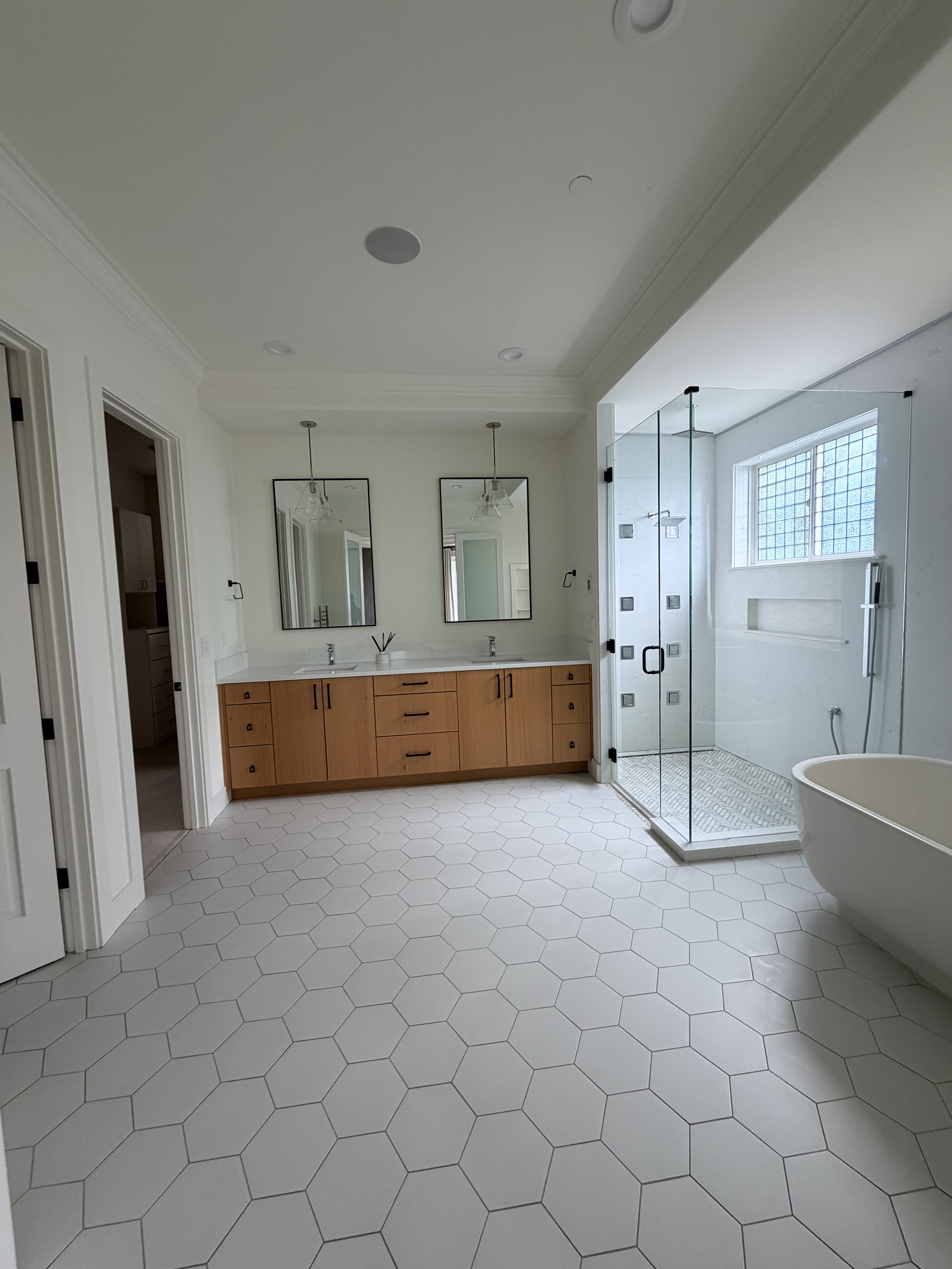 Spotless master bathroom with hex tile and glass shower