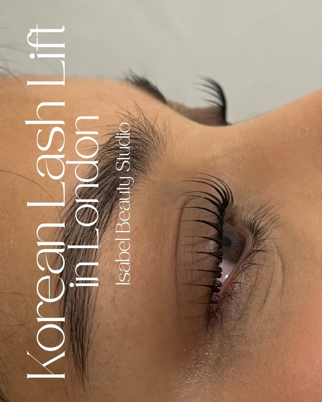 Close-up of a client’s eye with enhanced eyelashes and groomed eyebrows, promoting Isabel Beauty Studio.