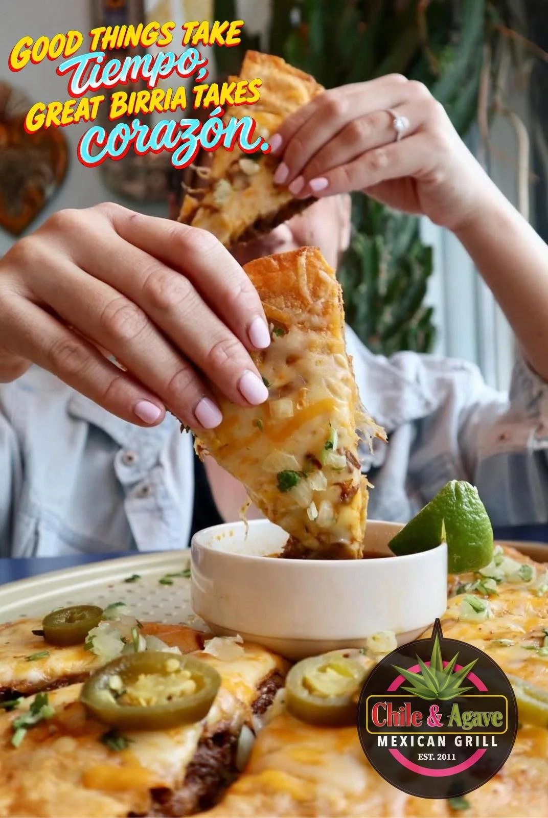 Hands dip a cheesy birria quesadilla into consommé, with lime and jalapeños, beside Chile & Agave Mexican Grill branding.