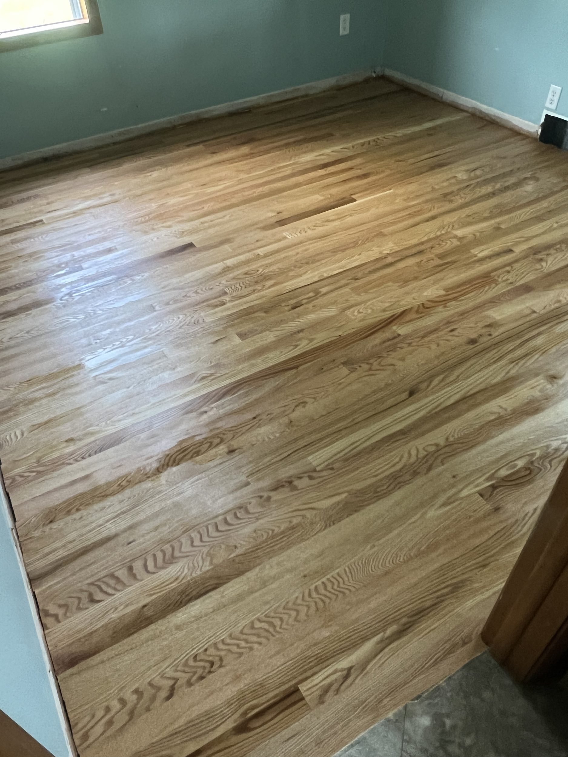 Refinished natural hardwood floor with visible grain