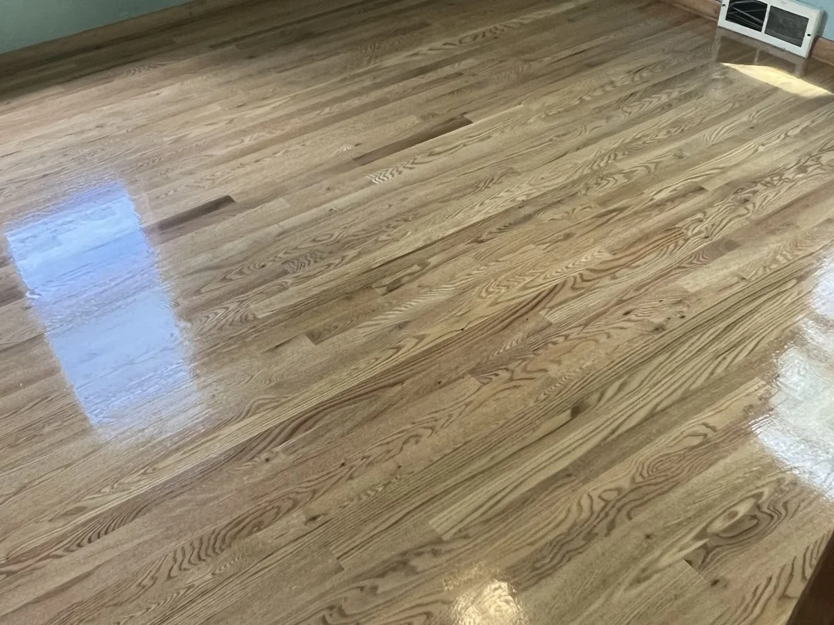 Polished hardwood floor with a natural wood grain pattern in a room.