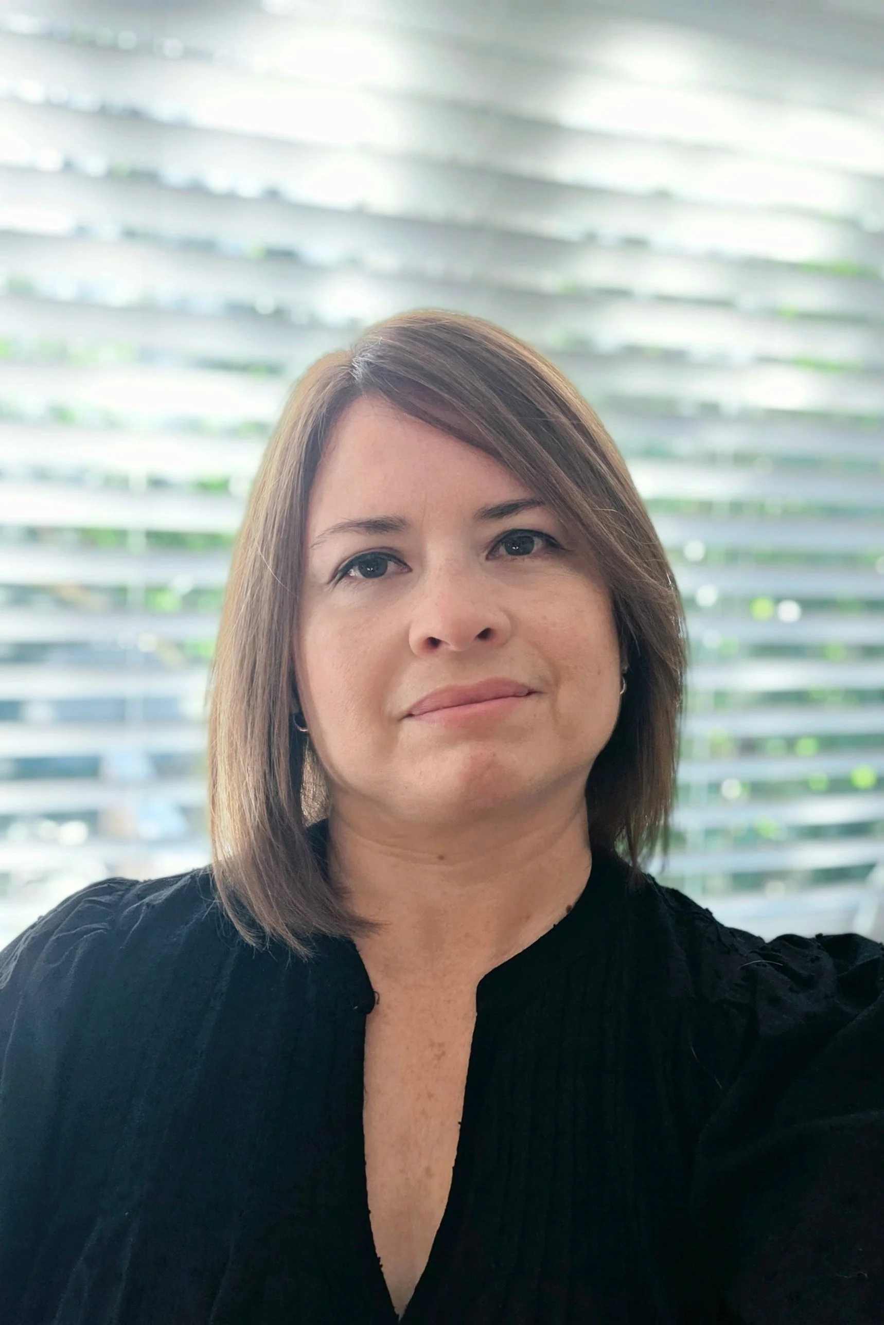 Headshot of owner by a well lit window
