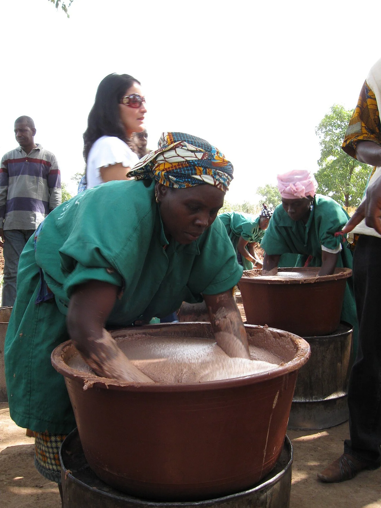 Women of the Zantiébougou shea cooperative in Mali working shea butter by hand in large basins