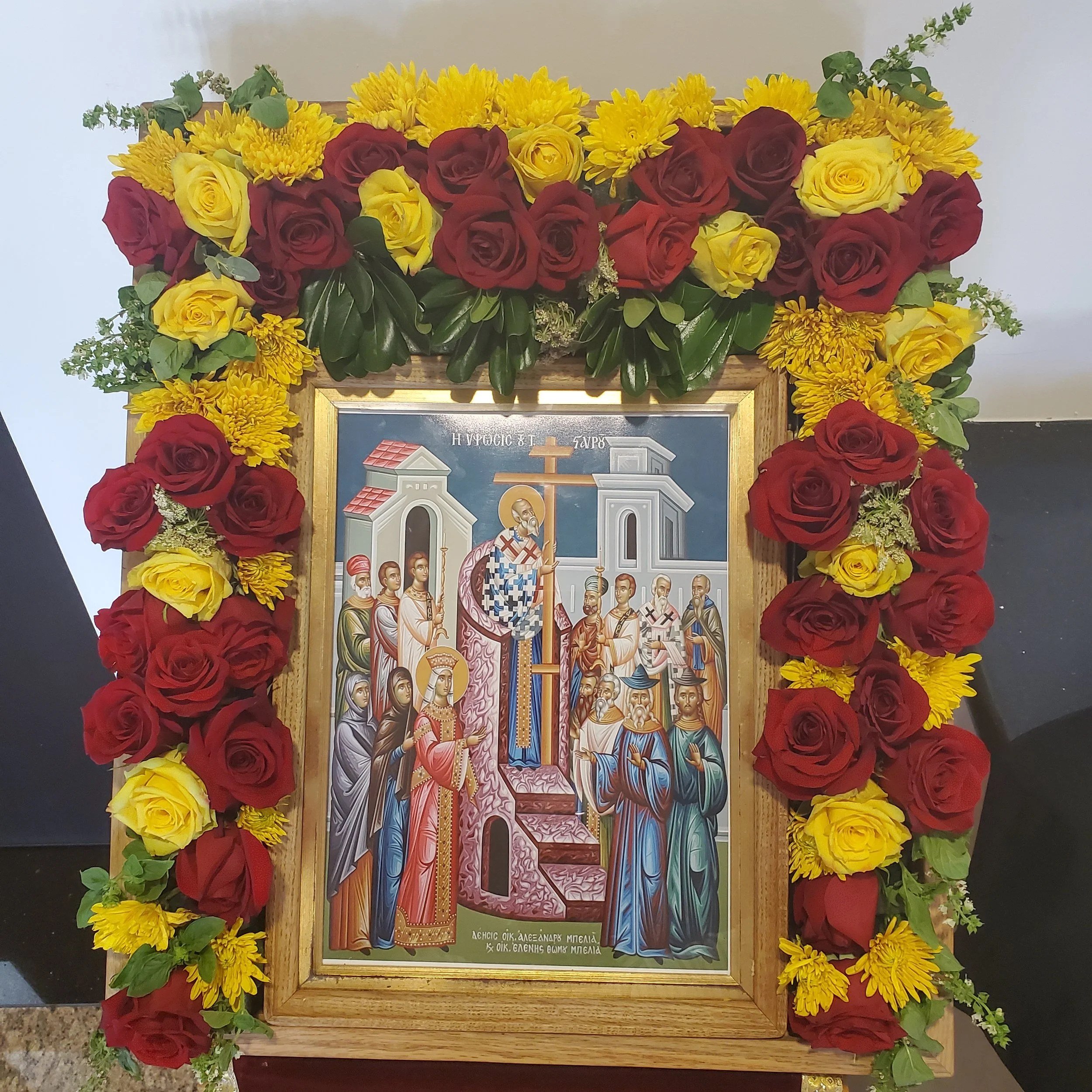 Feast icon framed with red and yellow roses