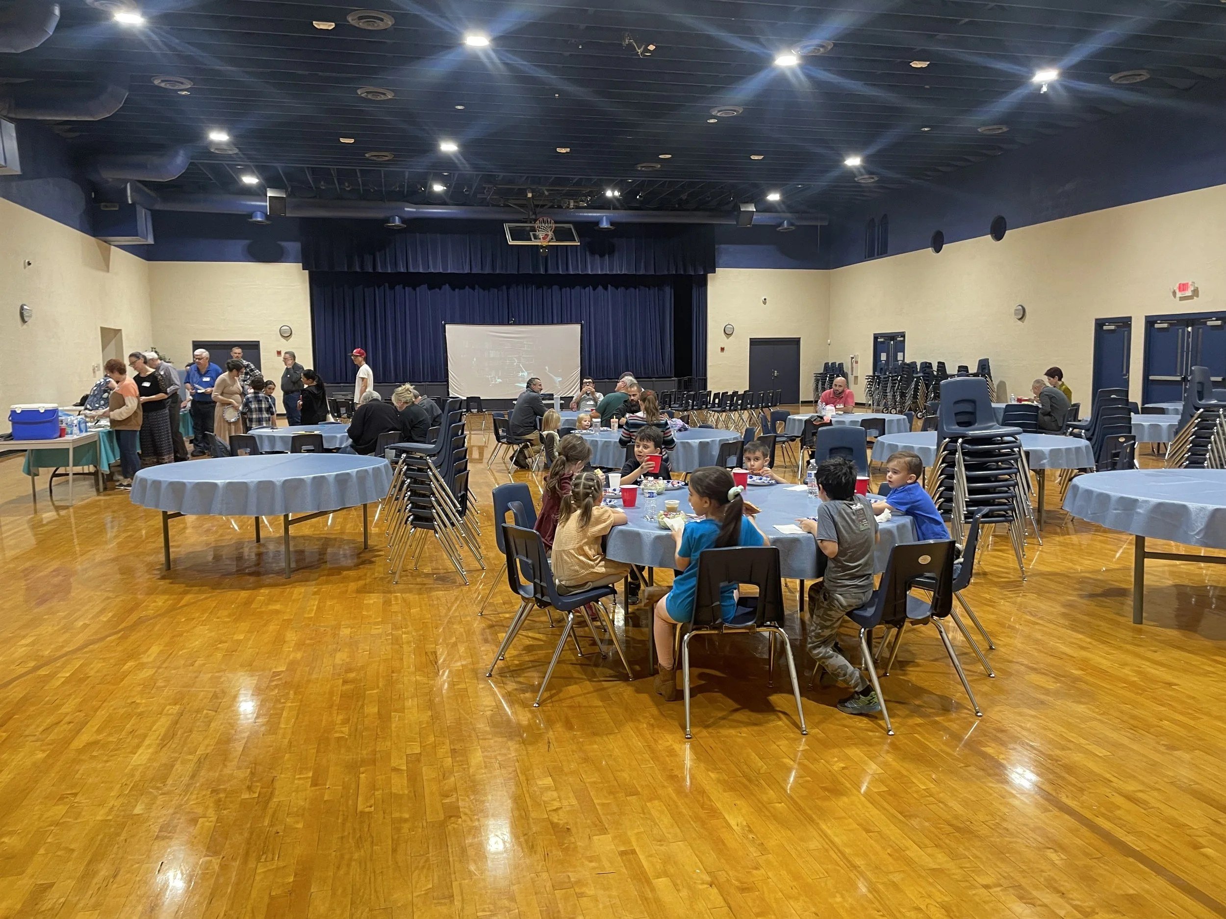 Men's Ministry gathering at round tables in the church hall