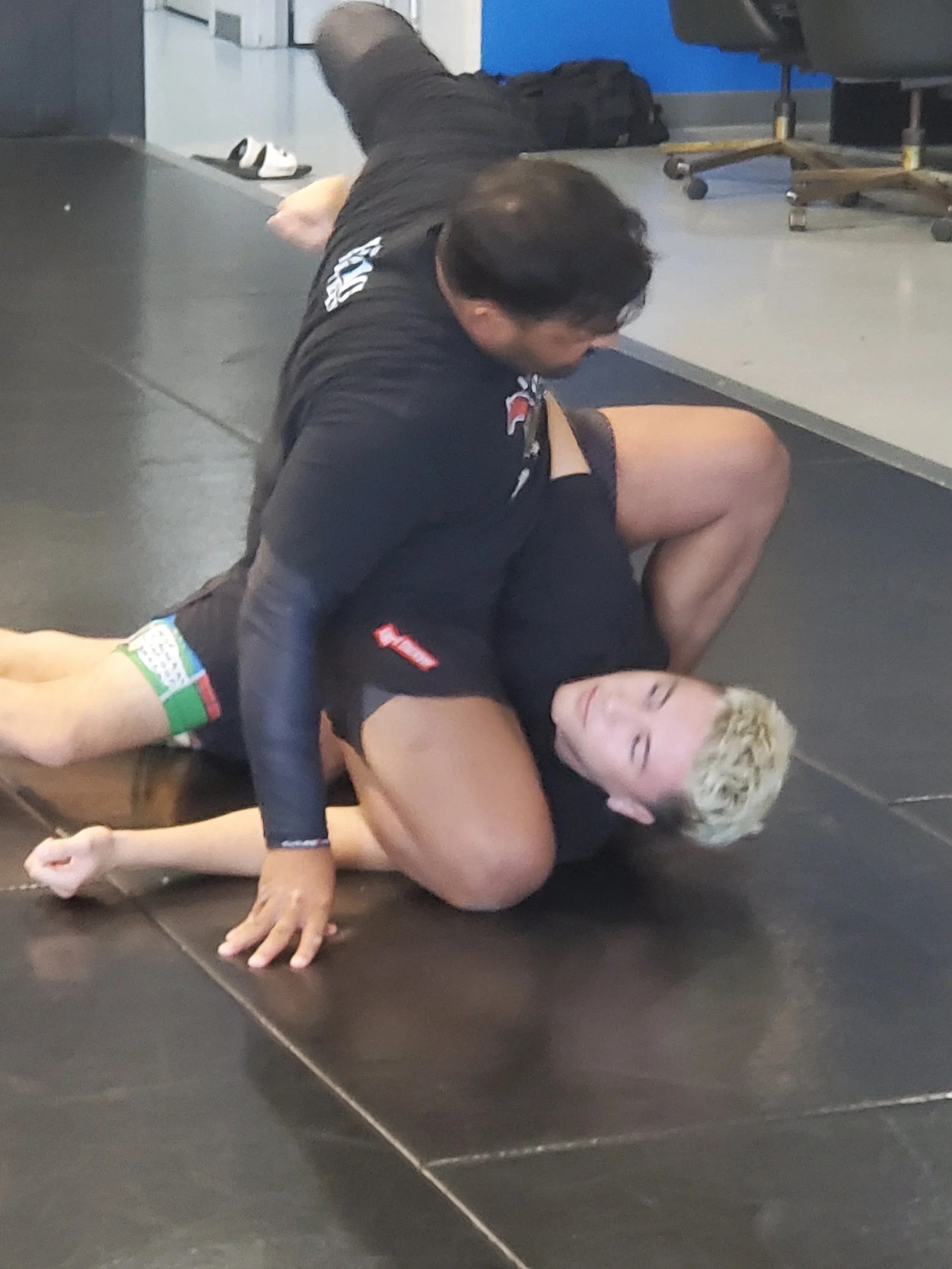 Men's Ministry members learning grappling techniques at a martial arts gym