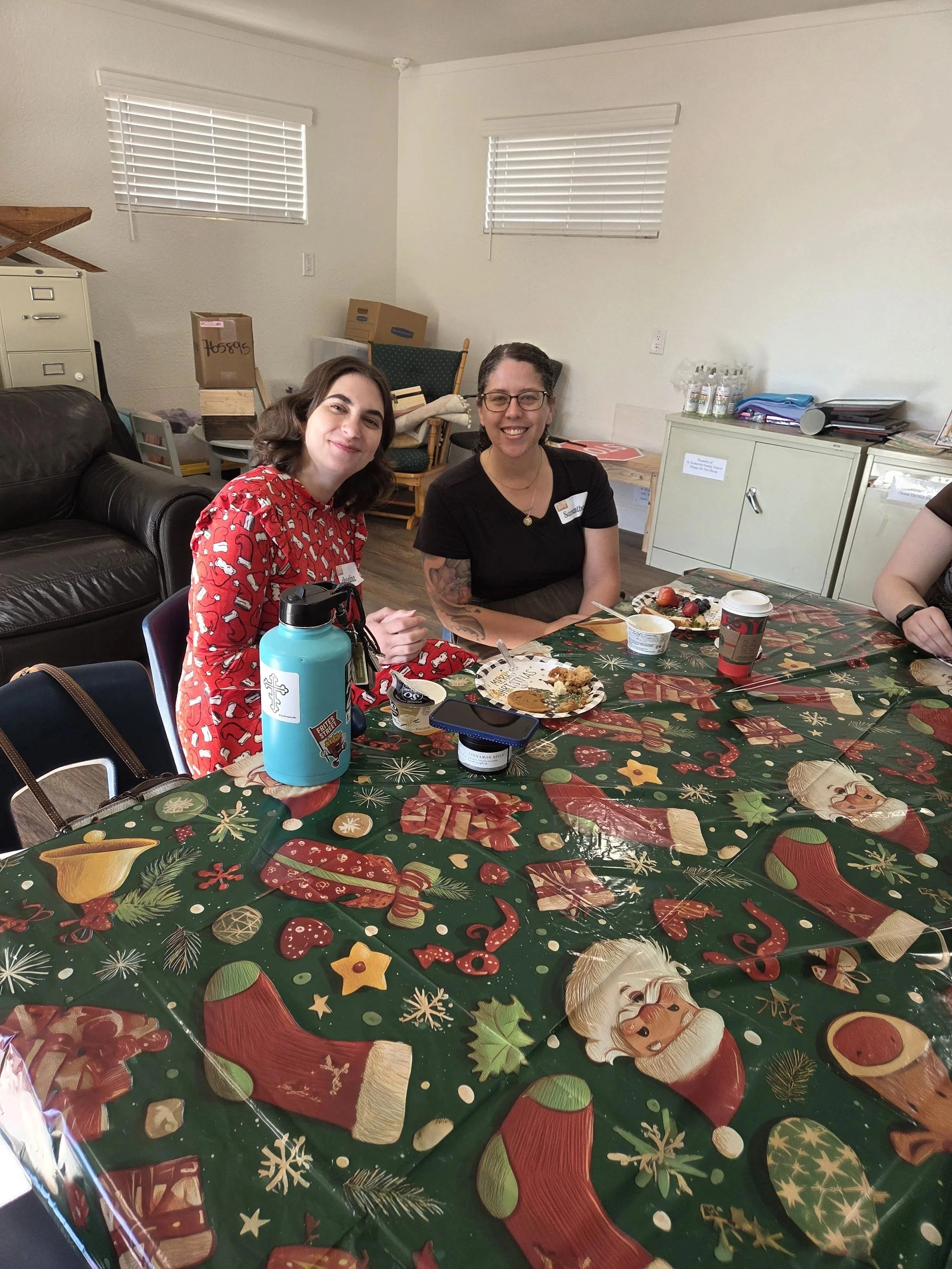 Women's Ministry members at a long table with a Christmas tablecloth