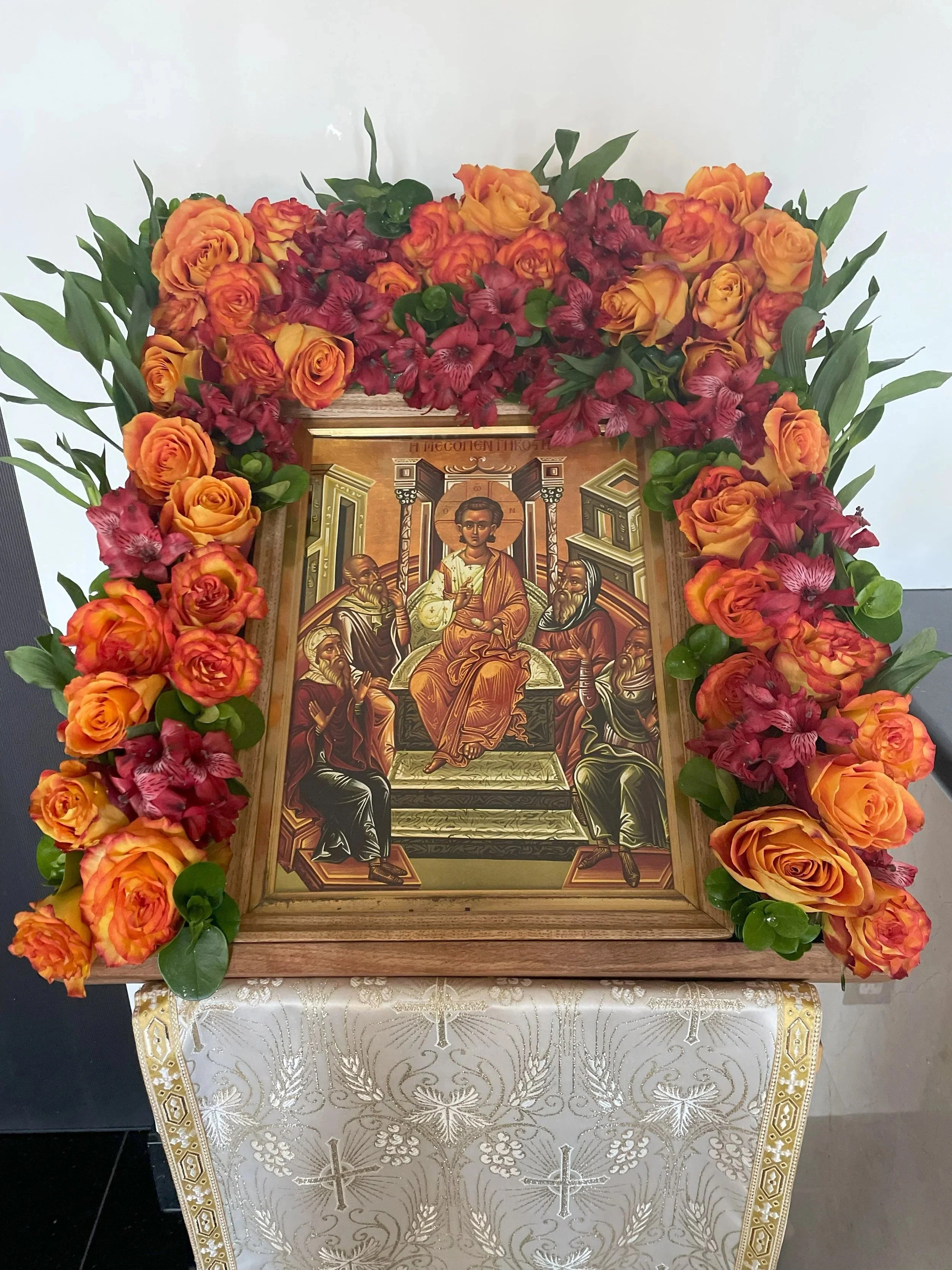 Feast icon framed with orange and red roses