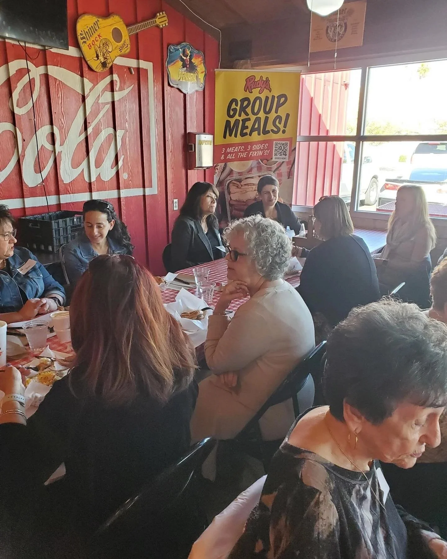 Women's Ministry members at lunch at tables with red-checkered tablecloths
