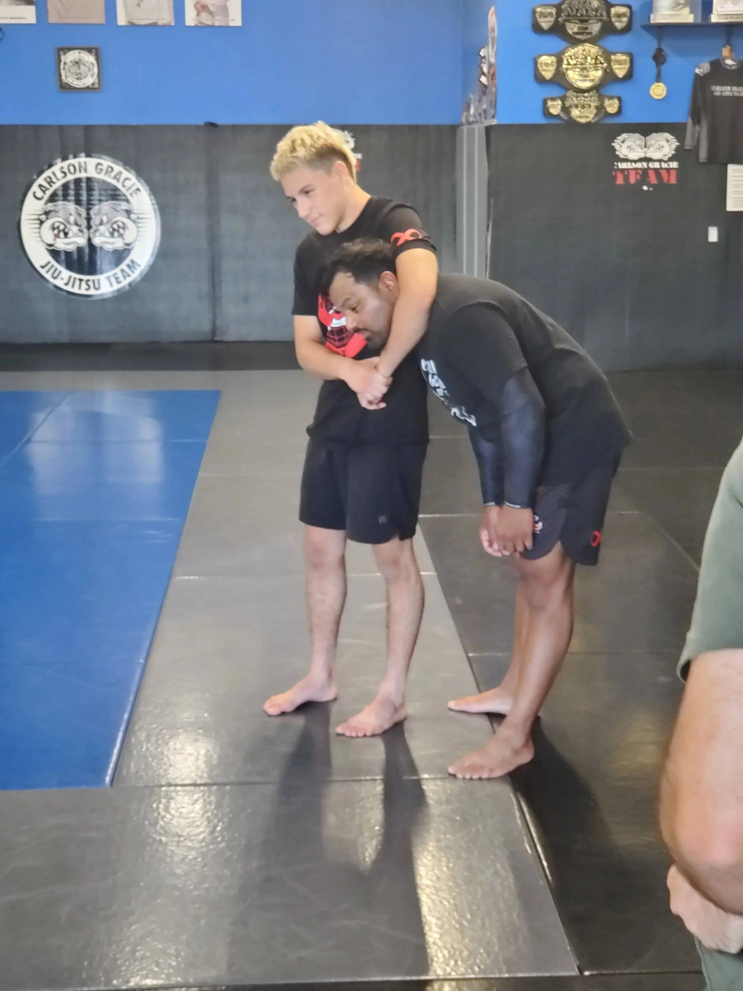 Men's Ministry members learning grappling techniques at a martial arts gym