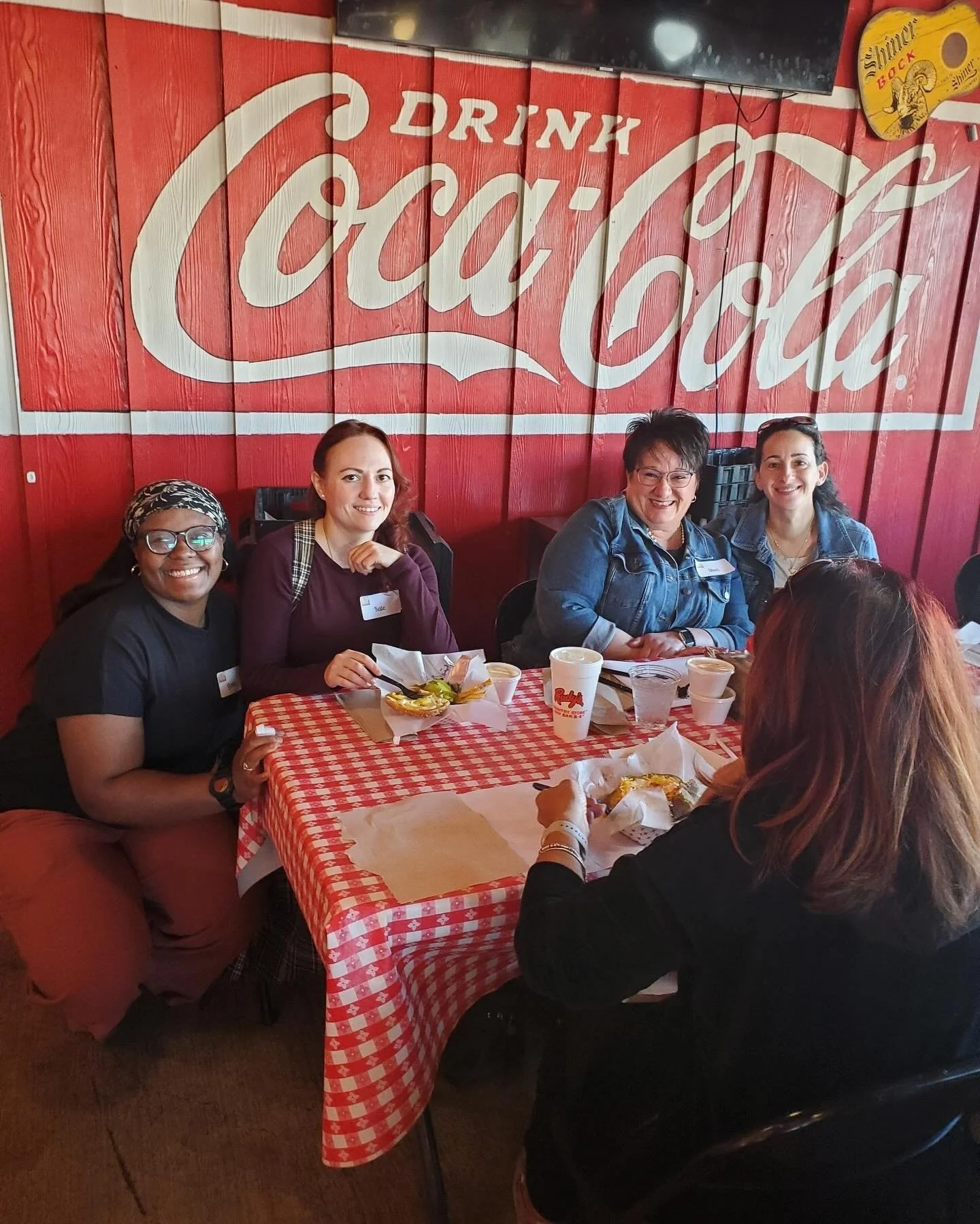 Women's Ministry members at lunch at tables with red-checkered tablecloths