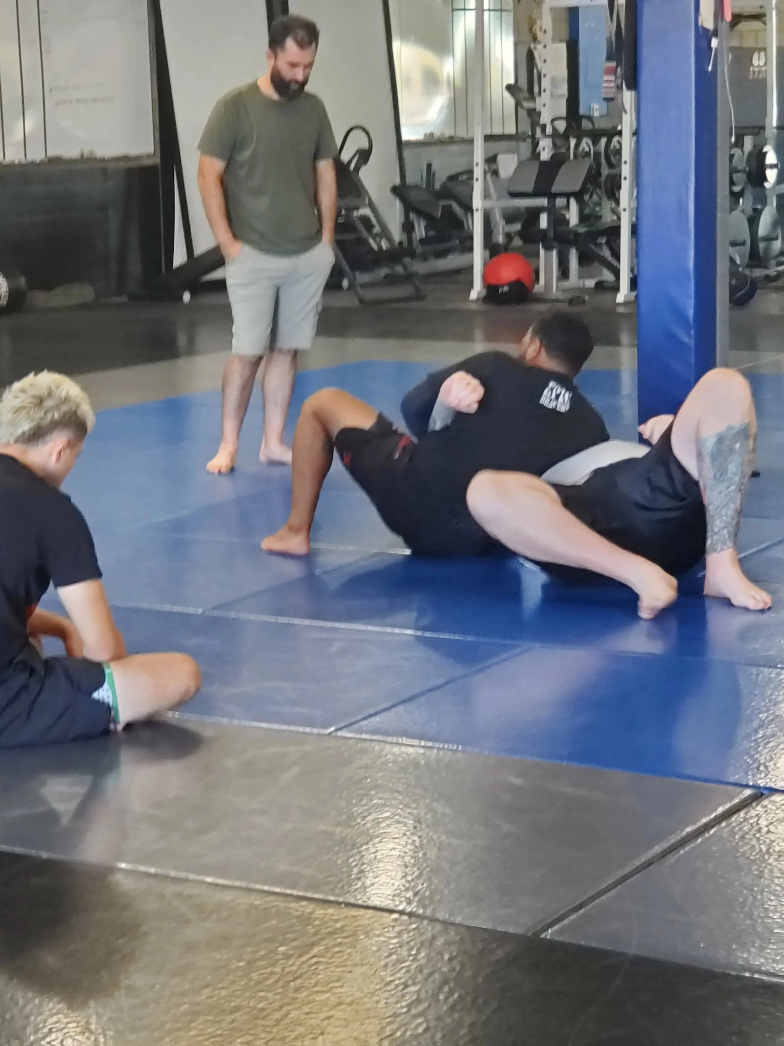 Men's Ministry members learning grappling techniques at a martial arts gym