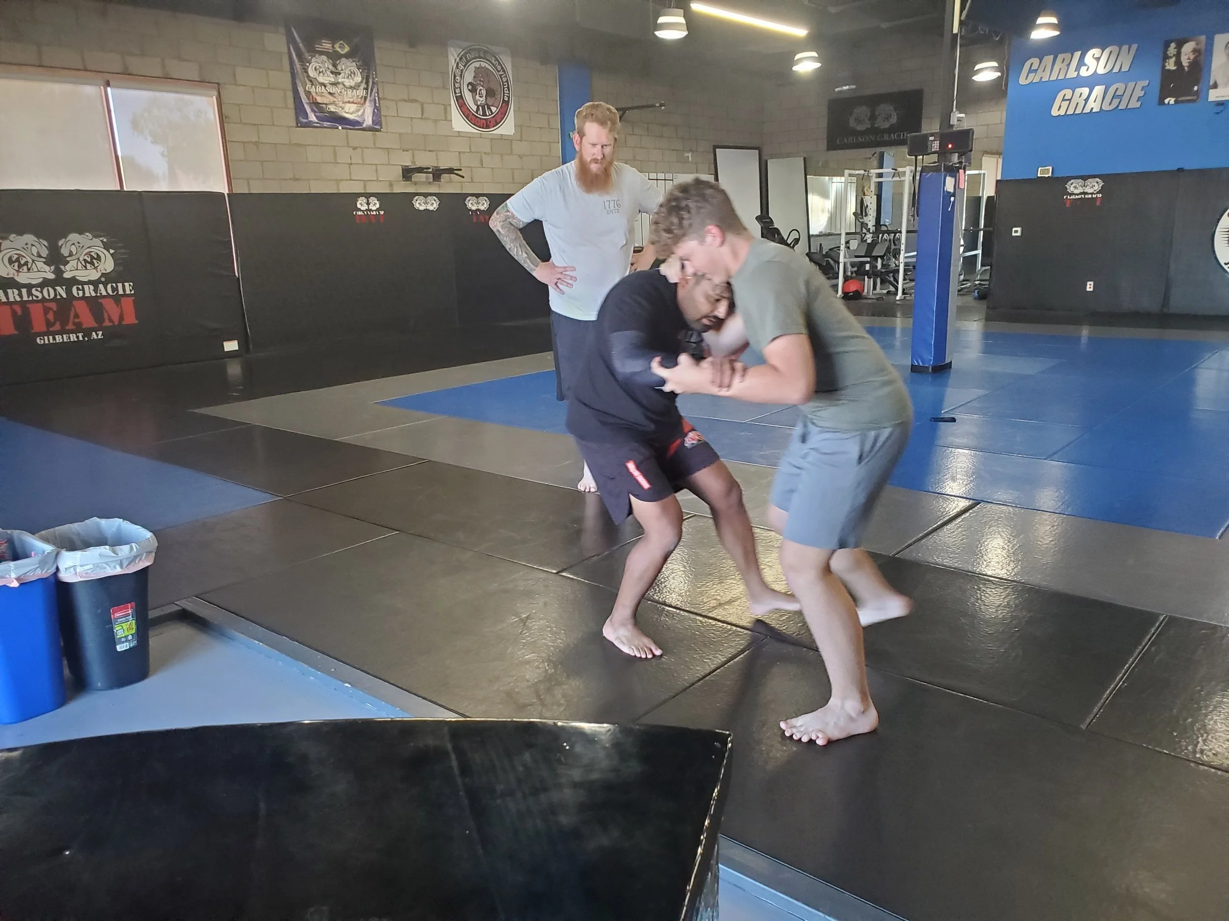 Men's Ministry members learning grappling techniques at a martial arts gym
