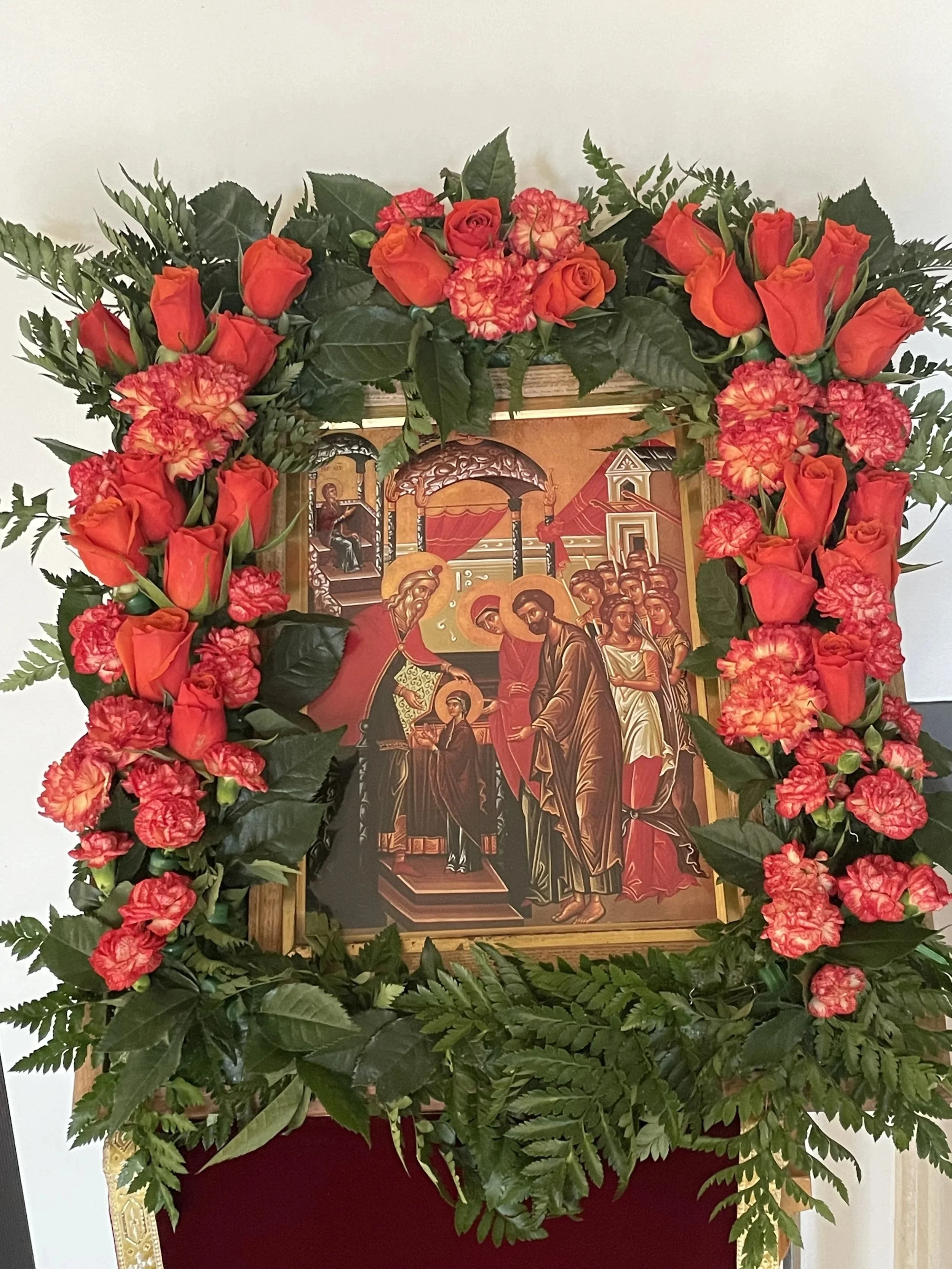 Feast icon framed with coral roses and greenery