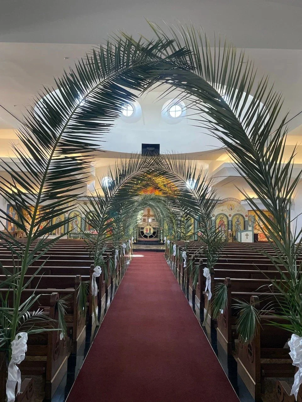 Palm fronds arching over the center aisle for Palm Sunday