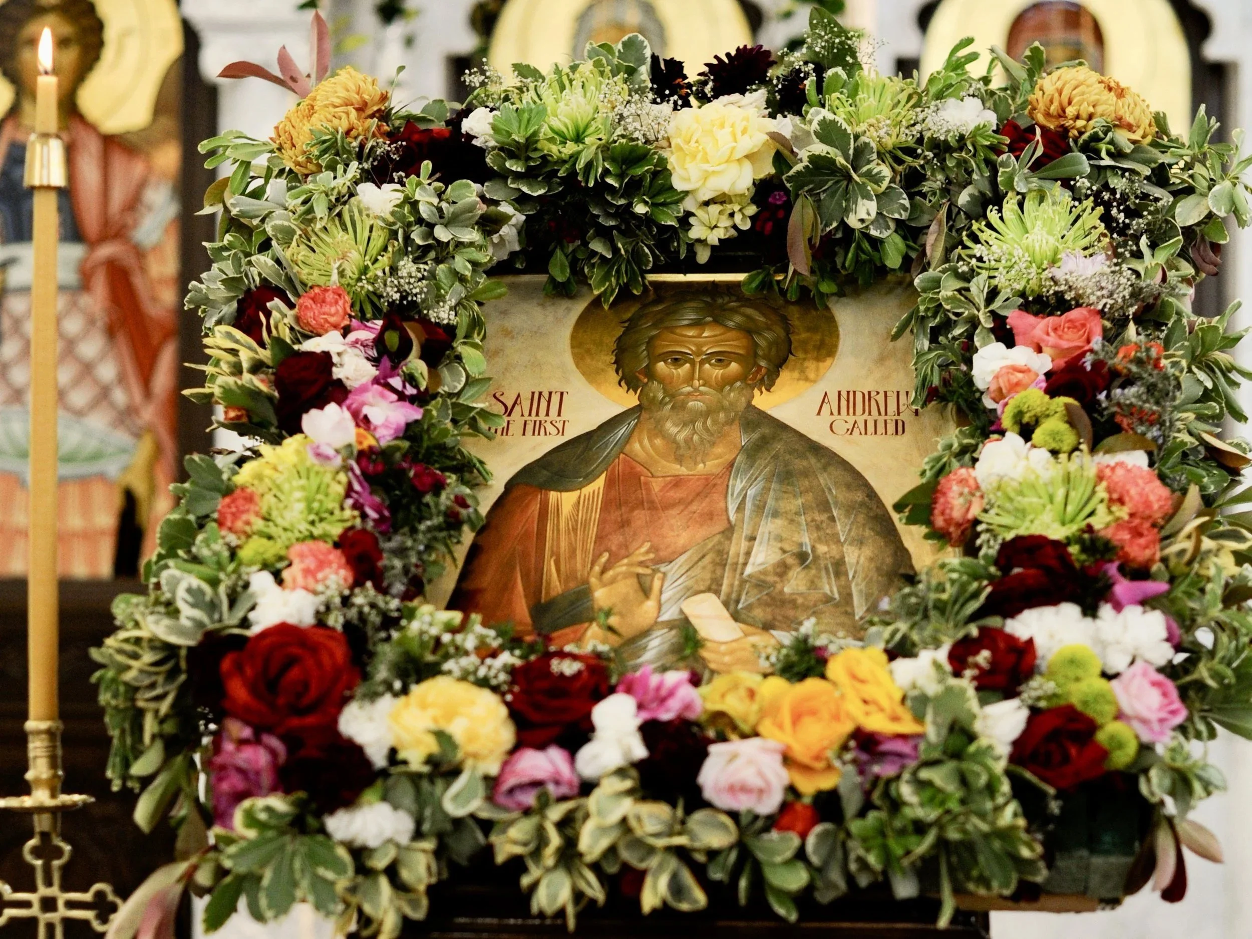 Icon of St. Andrew the First-Called framed in a lush garland of mixed flowers