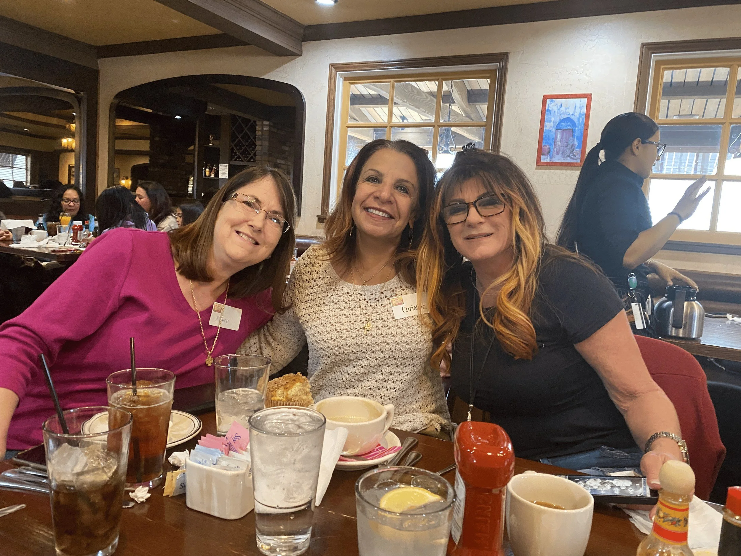 Small group of Women's Ministry members smiling at lunch
