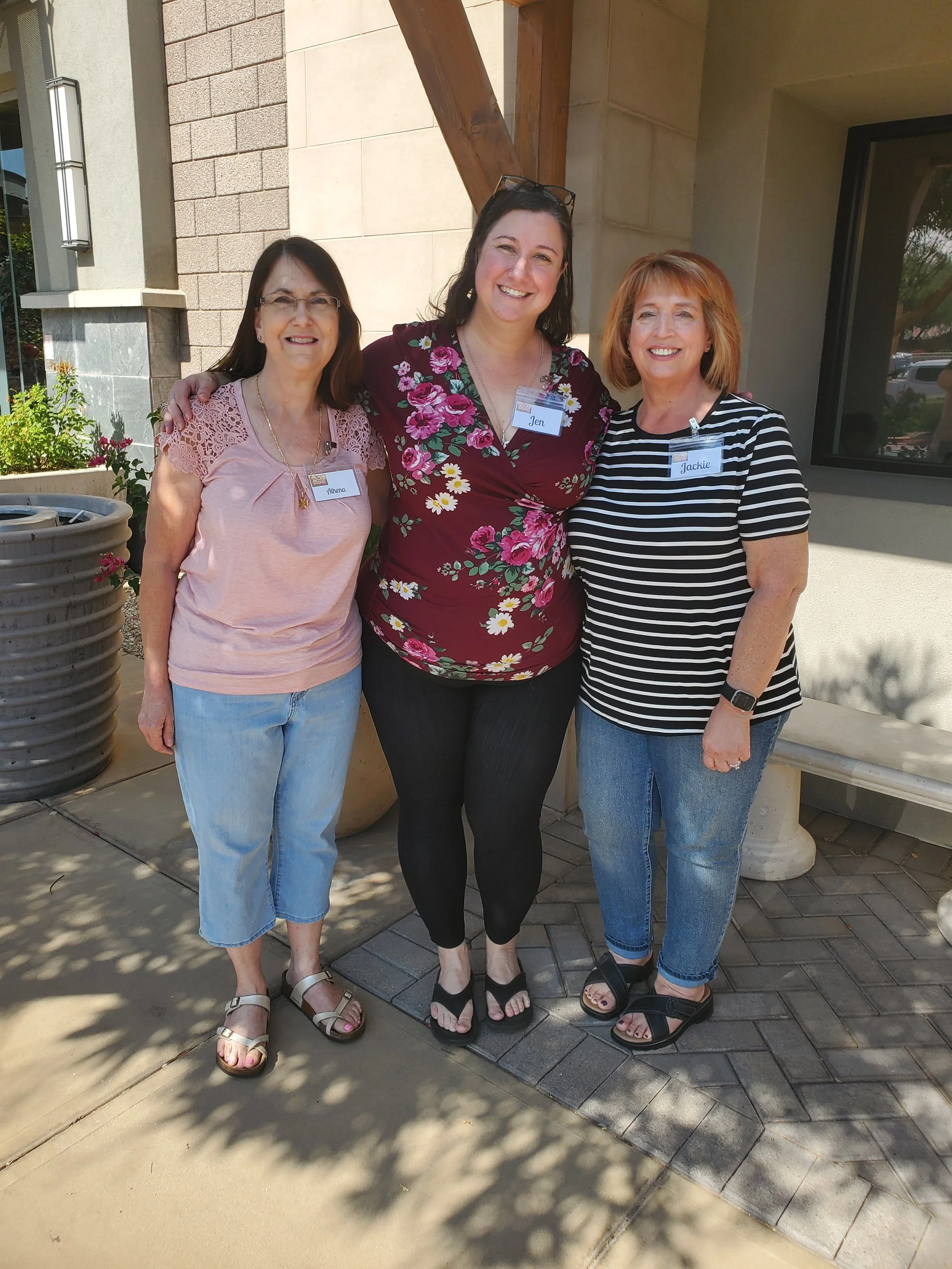 Three Women's Ministry members standing together outside a restaurant