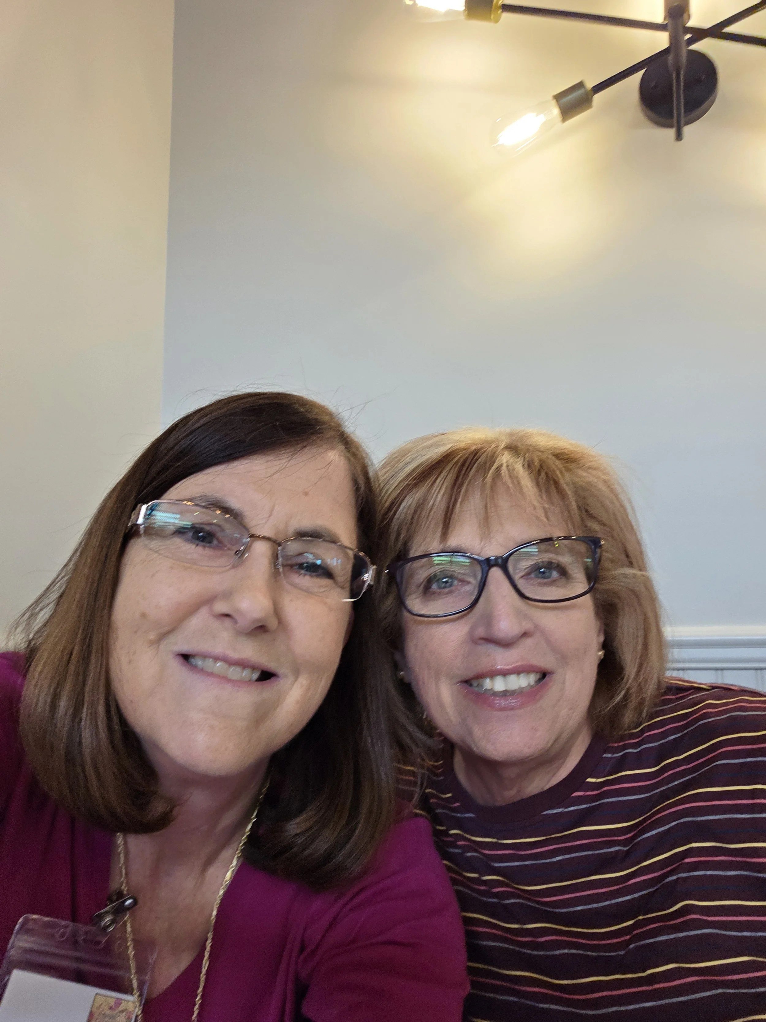 Two Women's Ministry members taking a selfie at lunch