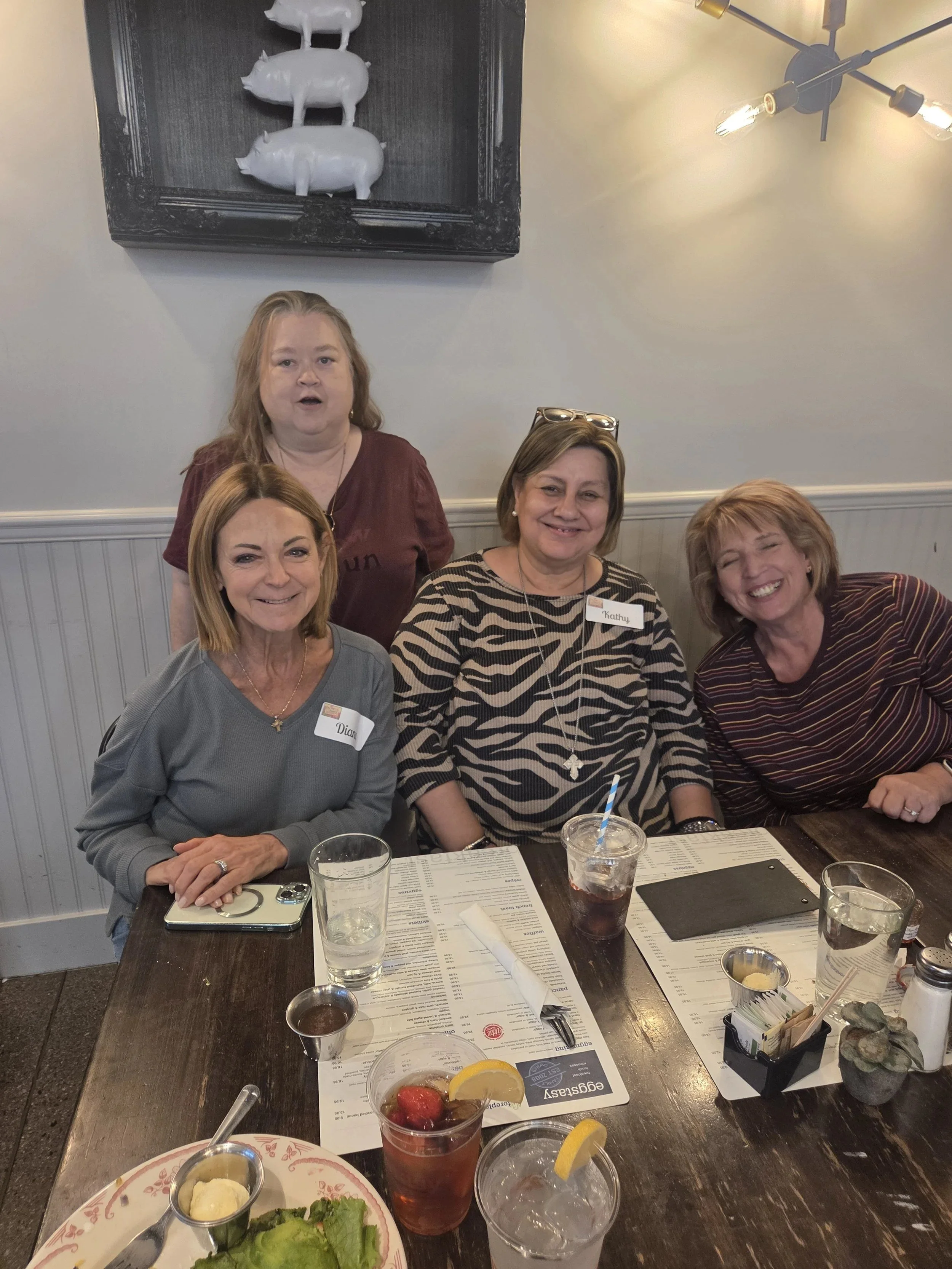 Small group of Women's Ministry members smiling at lunch
