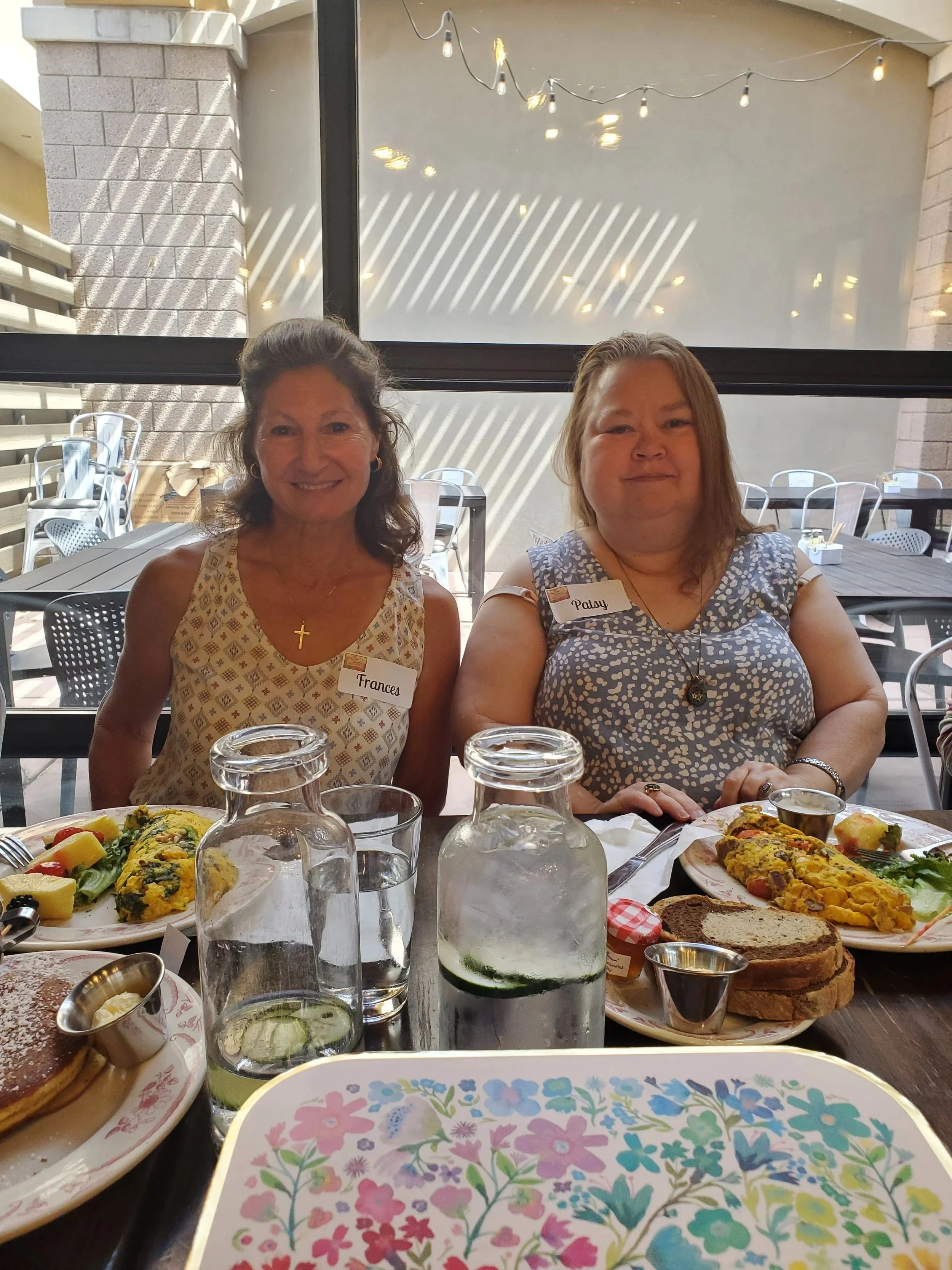 Small group of Women's Ministry members smiling at lunch
