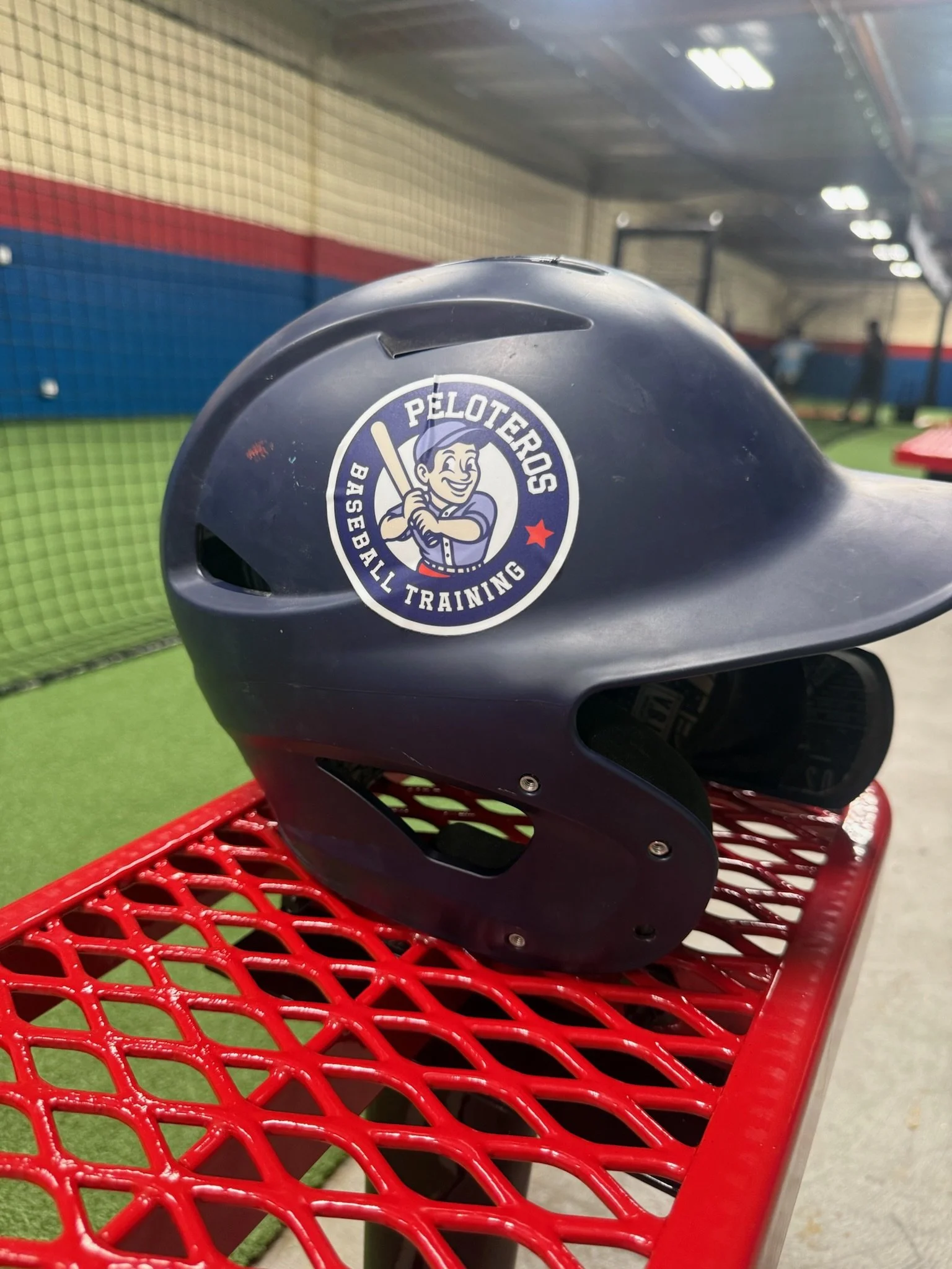 Batting helmet with Peloteros logo sticker