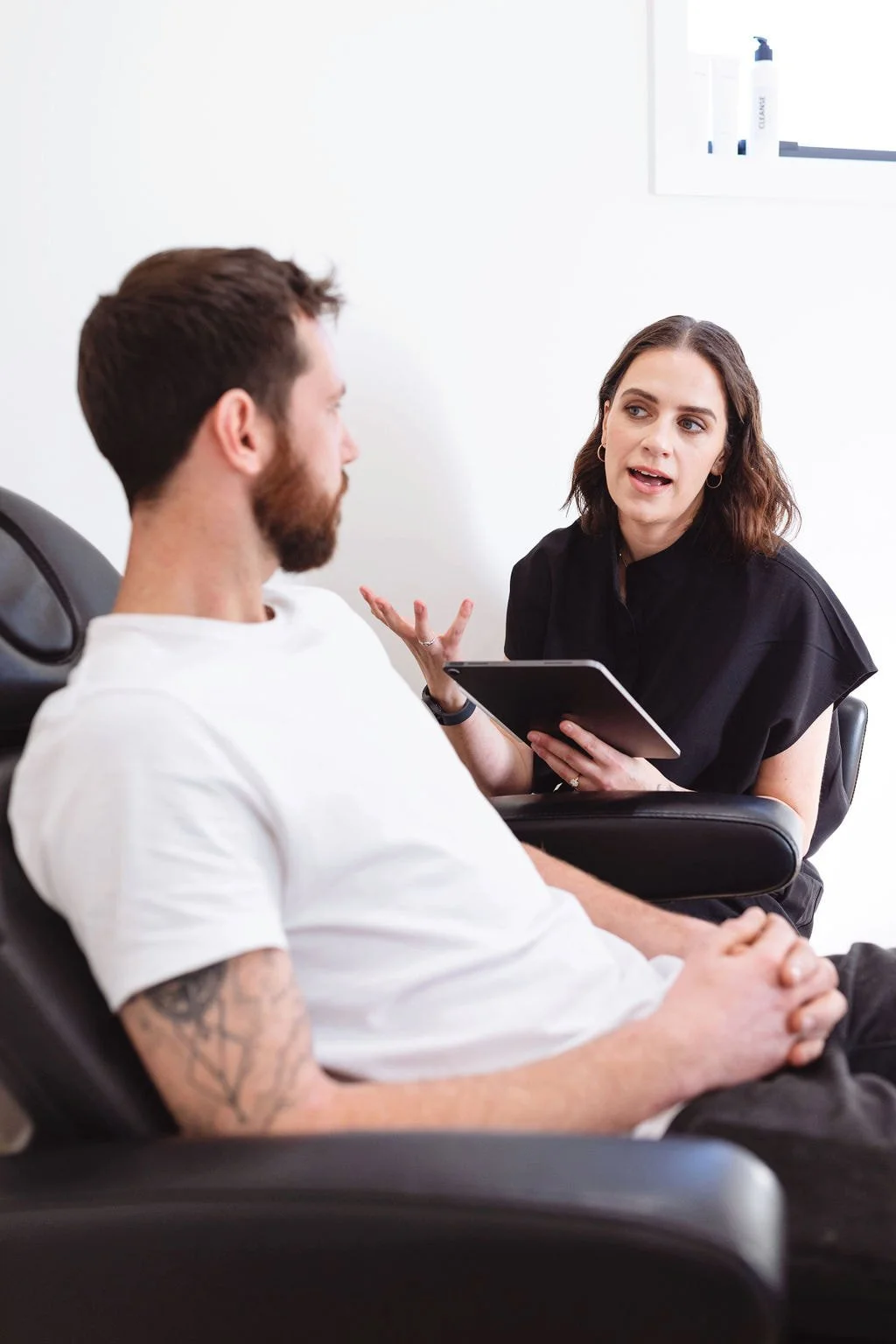 Registered nurse Jasmine talking with a client during a skin consultation at Reform Skin Studio, Frankton, Queenstown