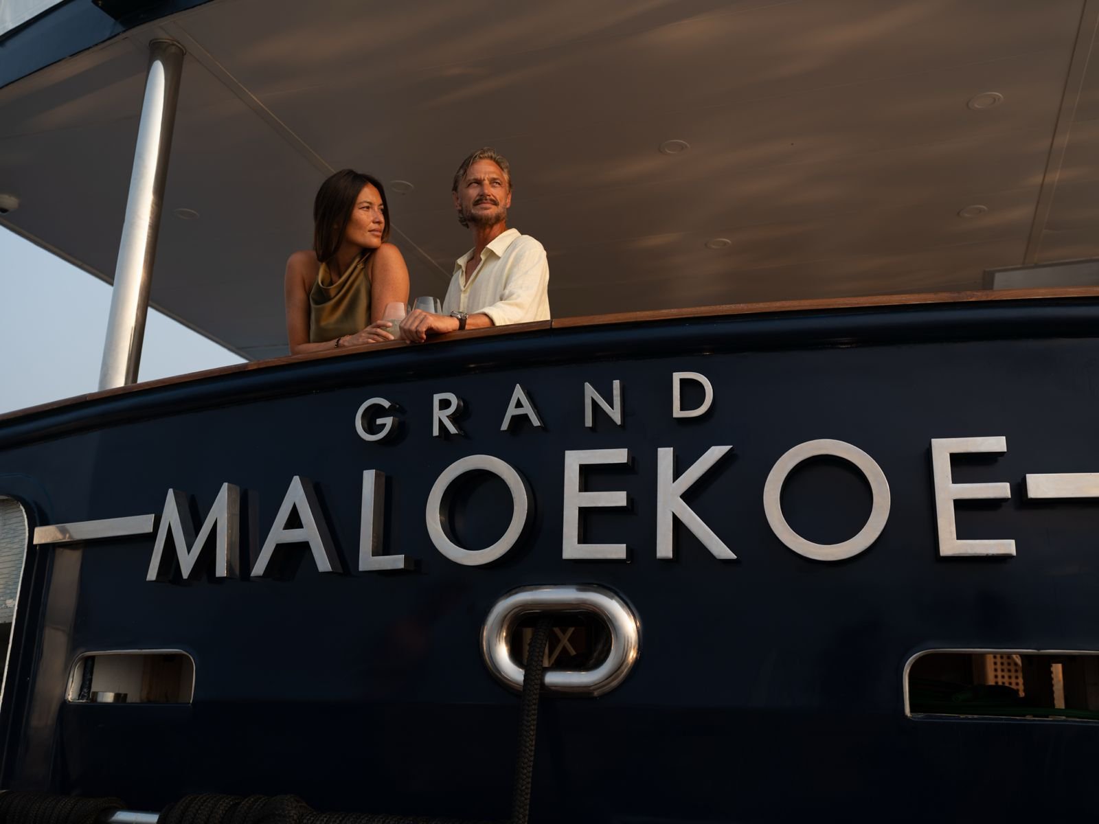 Couple standing on the deck of the Grand Maeloeko yacht