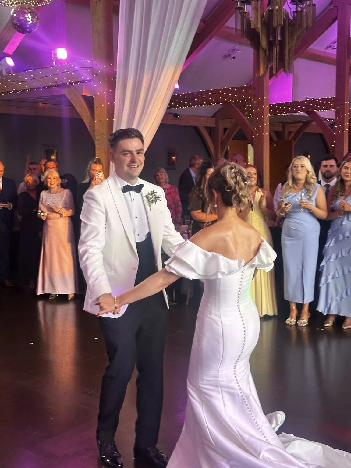Bride and groom dancing together at their wedding reception, surrounded by guests, captured for Love, Blair's wedding content creation portfolio.