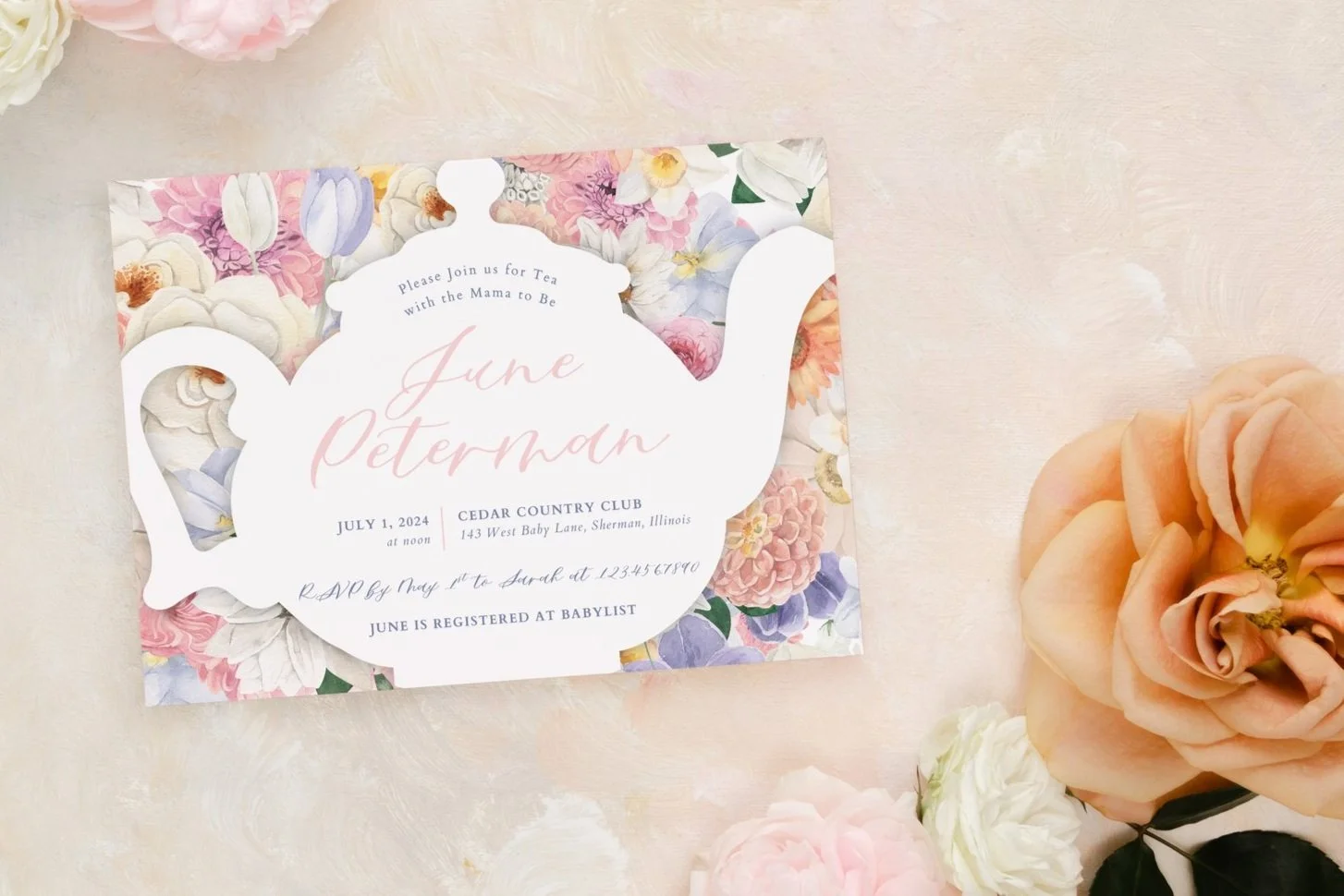 A tea party invitation designed as a teapot with floral pattern background, announcing June Perman’s baby shower on July 1, 2024, at Cedar Country Club in Sherman, Illinois, with guest RSVP details and registry information. Surrounding the invitation are pink, white, and peach roses.