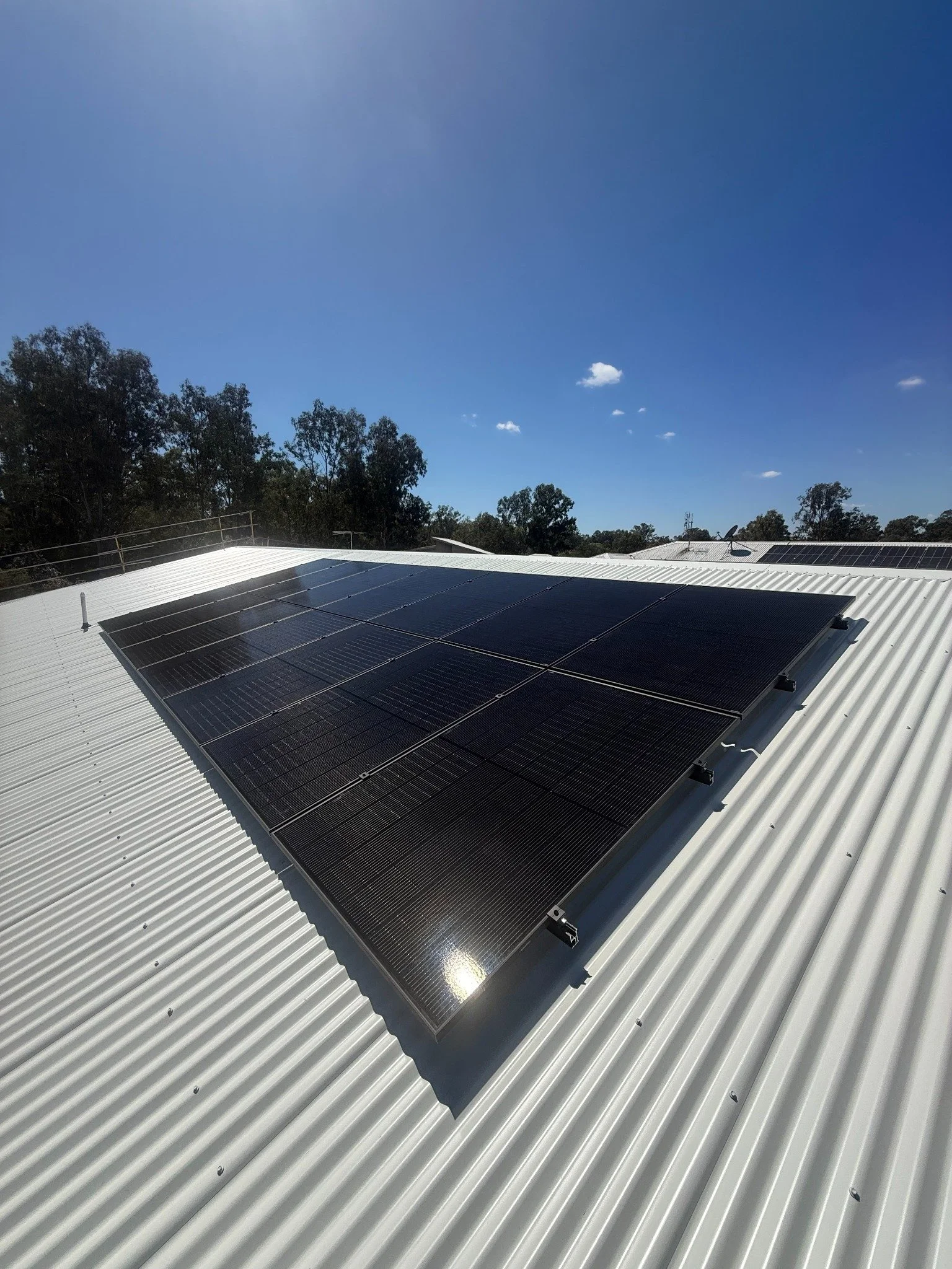 Surf to Summit rooftop solar installation on a white metal roof