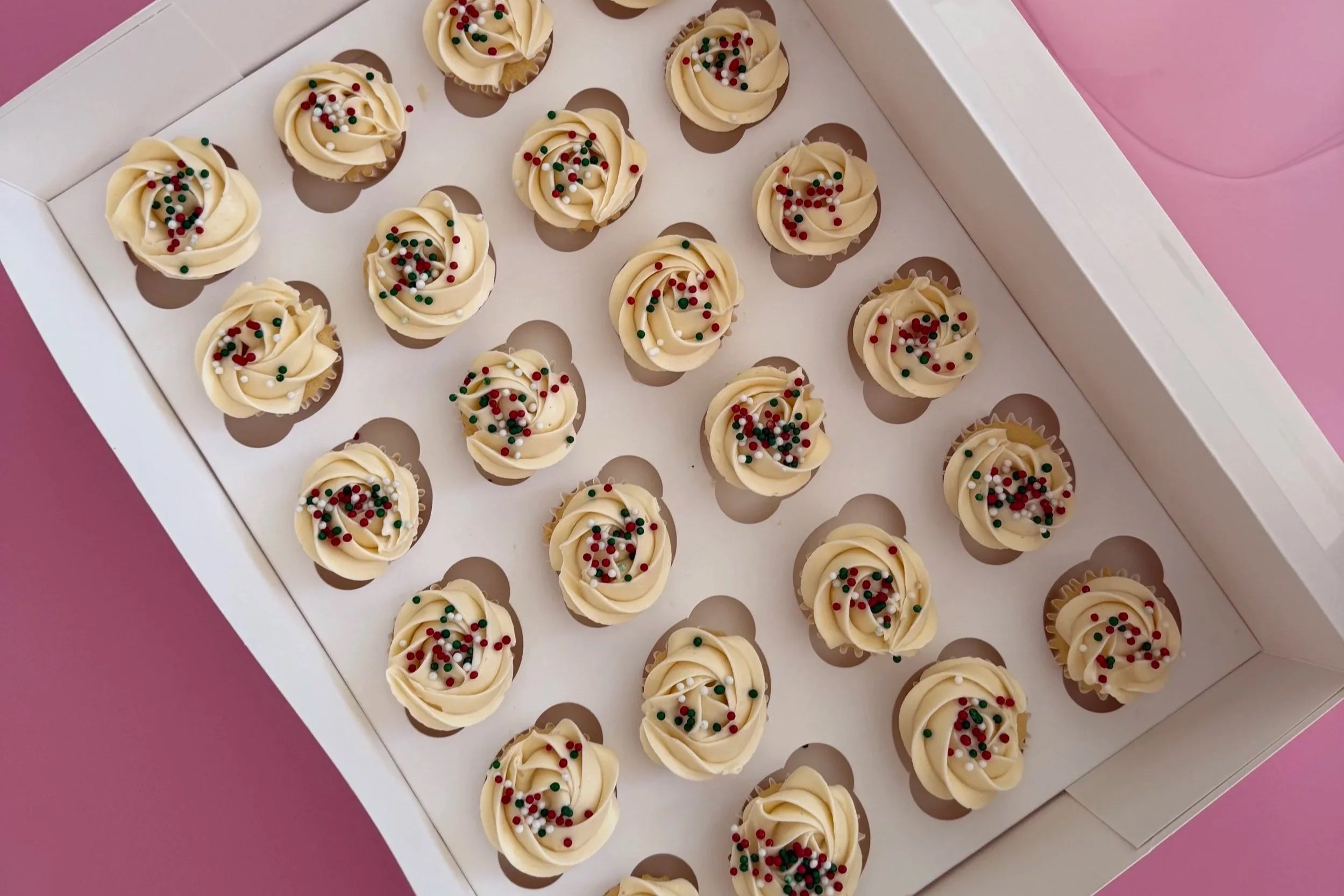 Vanilla mini cupcakes decorated with swiss meringue buttercream and sprinkles